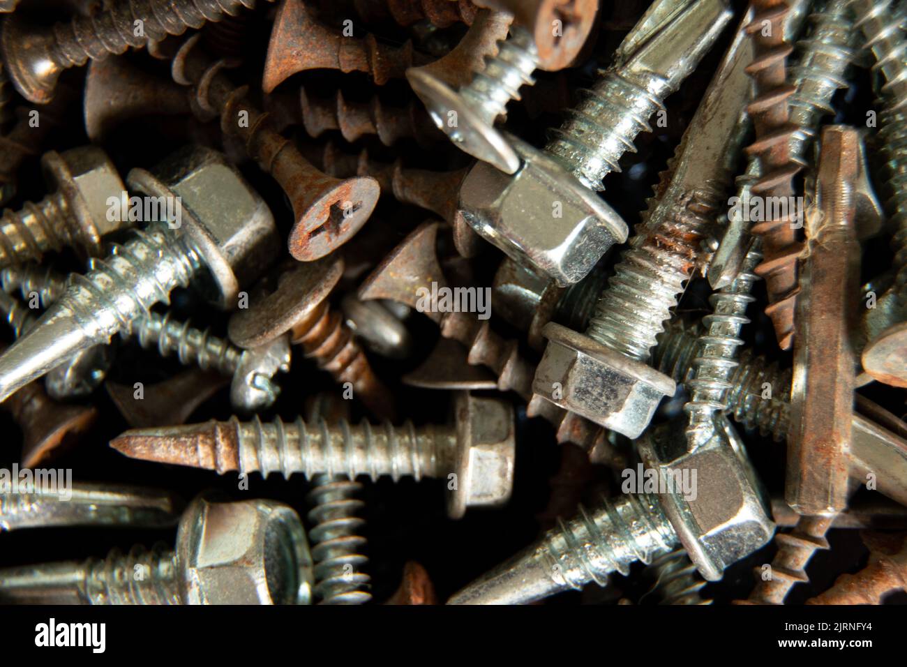 old screws and nuts and screws as background, screws and nails for