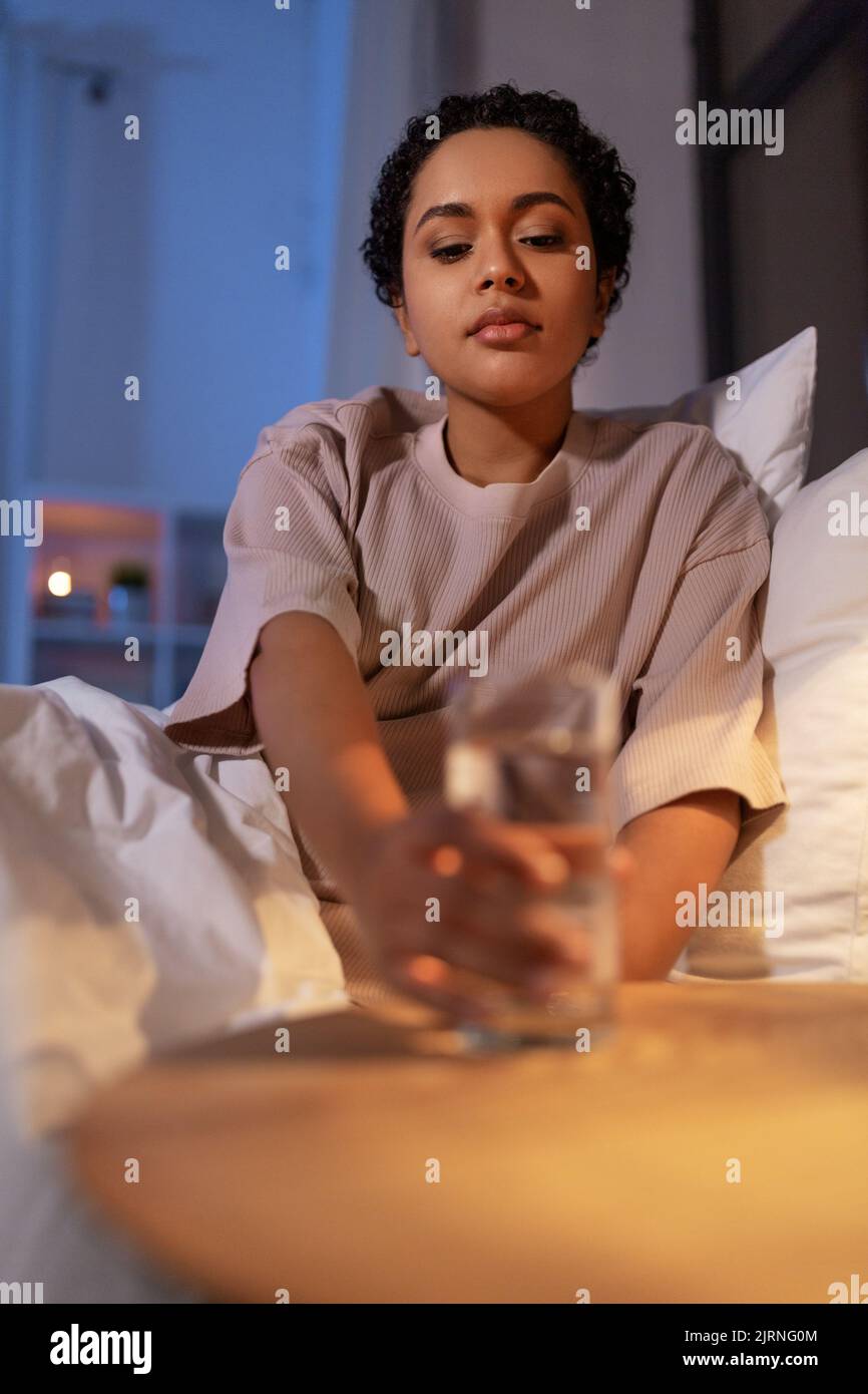 african american woman drinking water at night Stock Photo Alamy