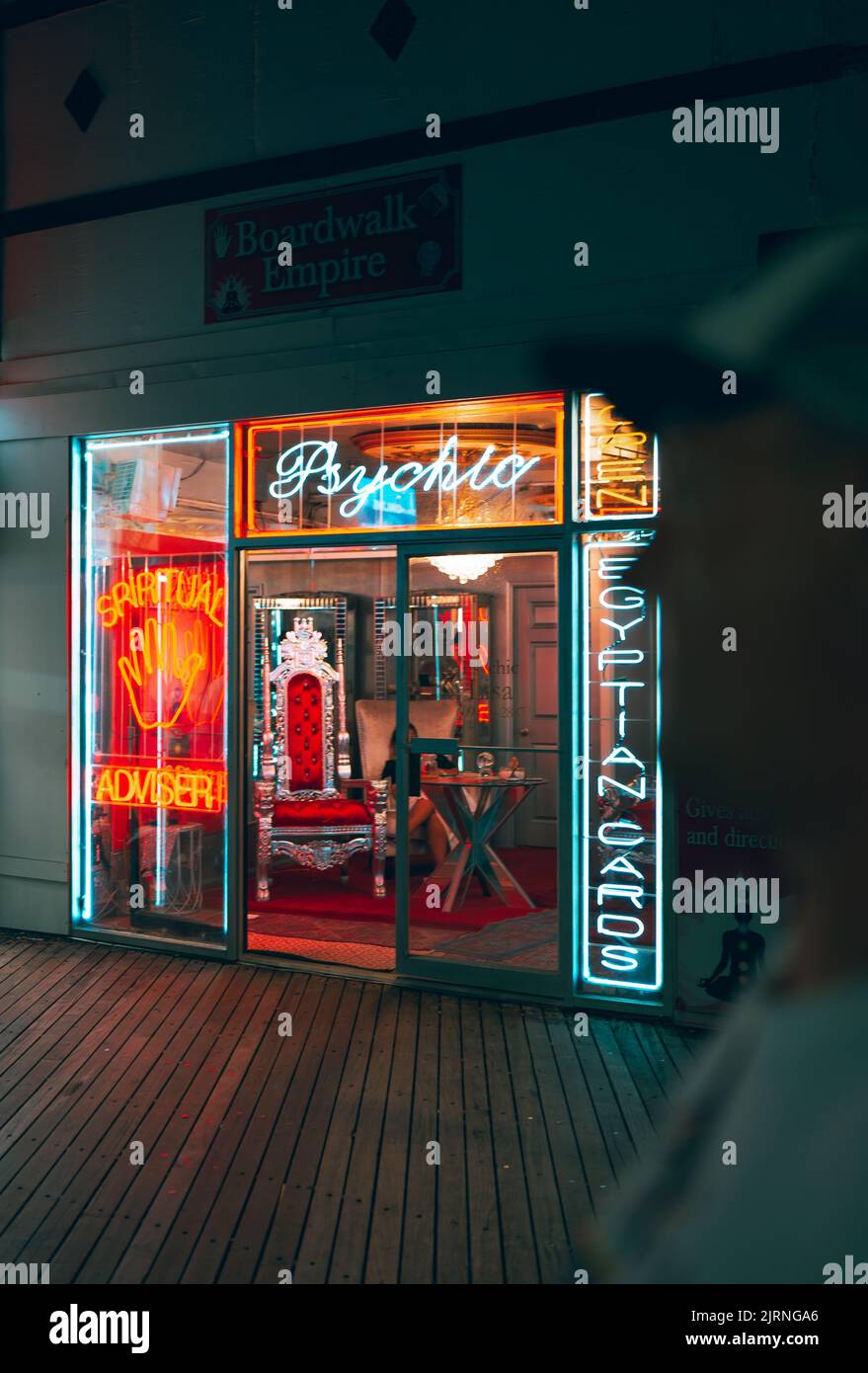 A vertical shot of neon signs lit at night at Boardwalk Empire Stock Photo