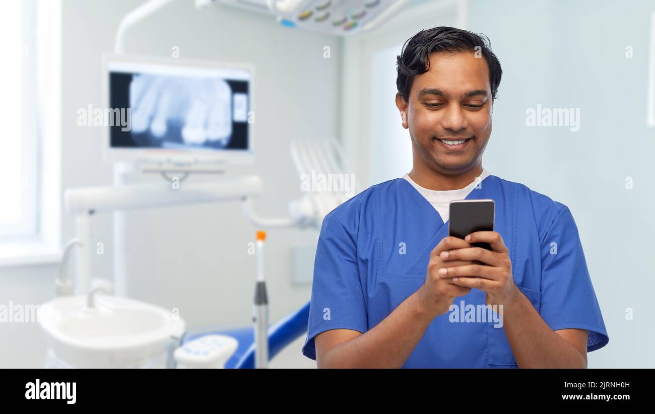 Indian male doctor using mobile hi-res stock photography and images - Alamy