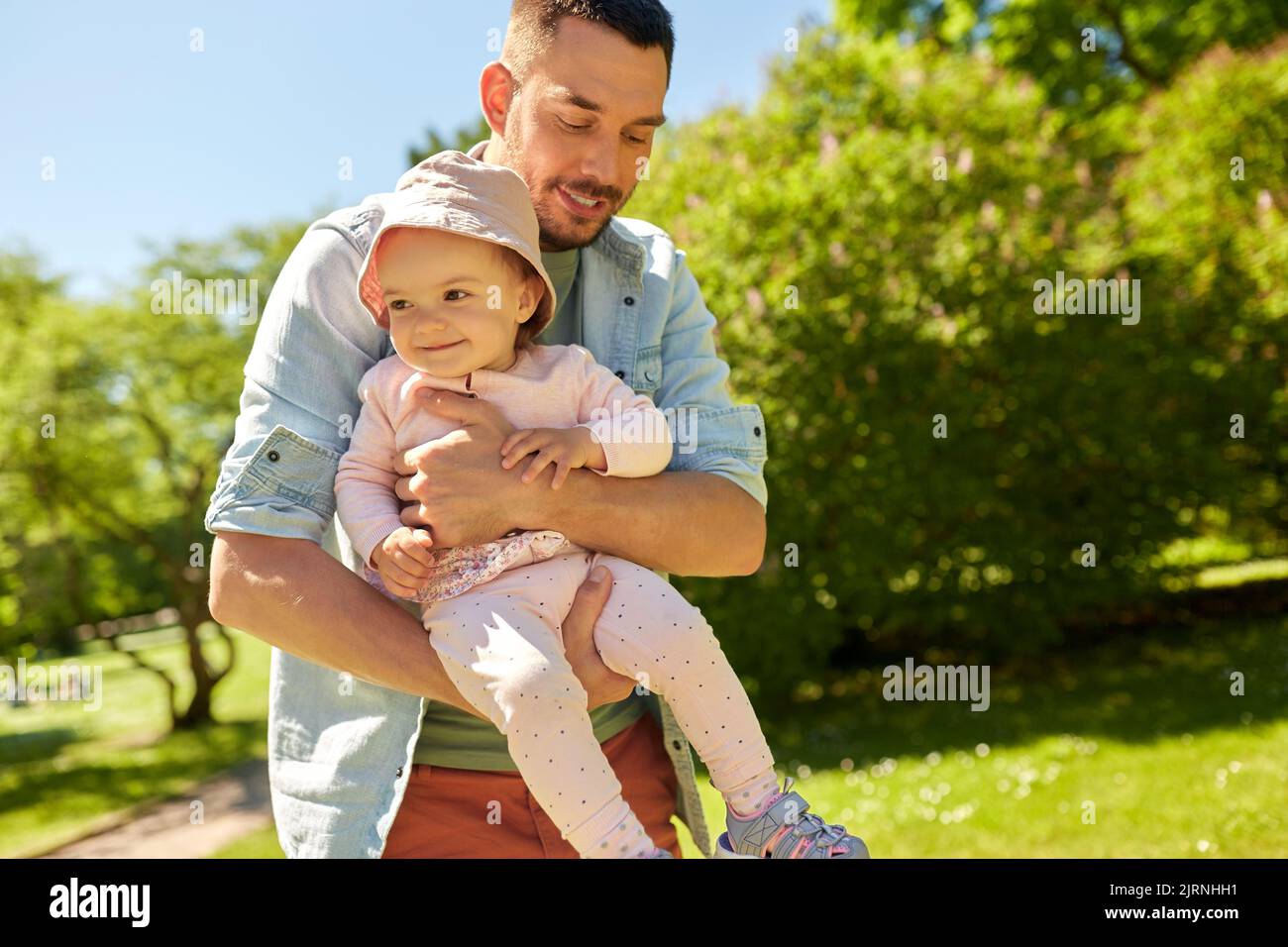 happy father with baby daughter at summer park Stock Photo - Alamy