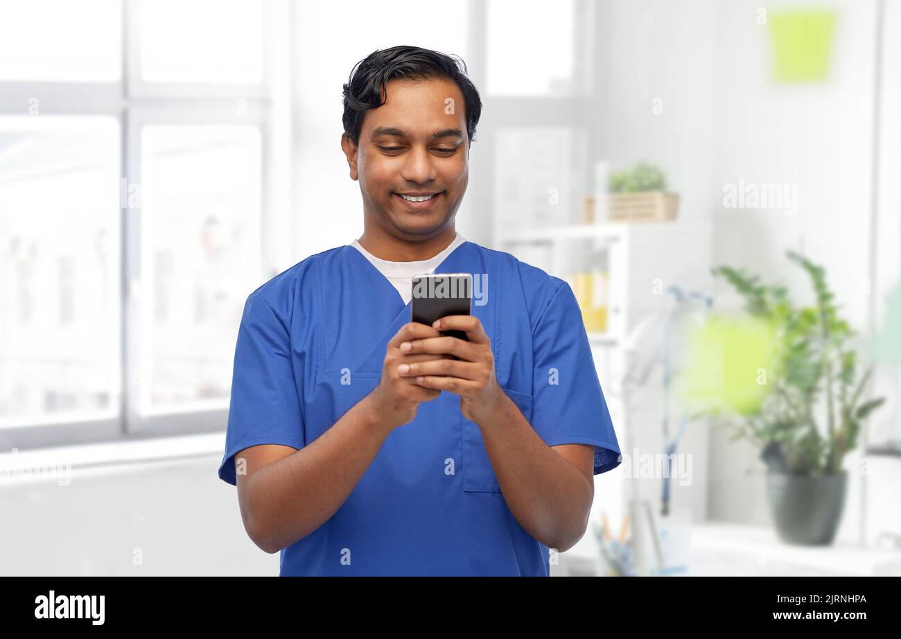 Indian male doctor using mobile hi-res stock photography and images - Alamy