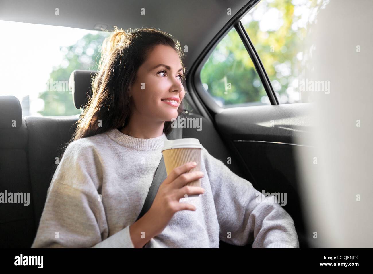 woman or passenger drinking coffee in taxi car Stock Photo Alamy