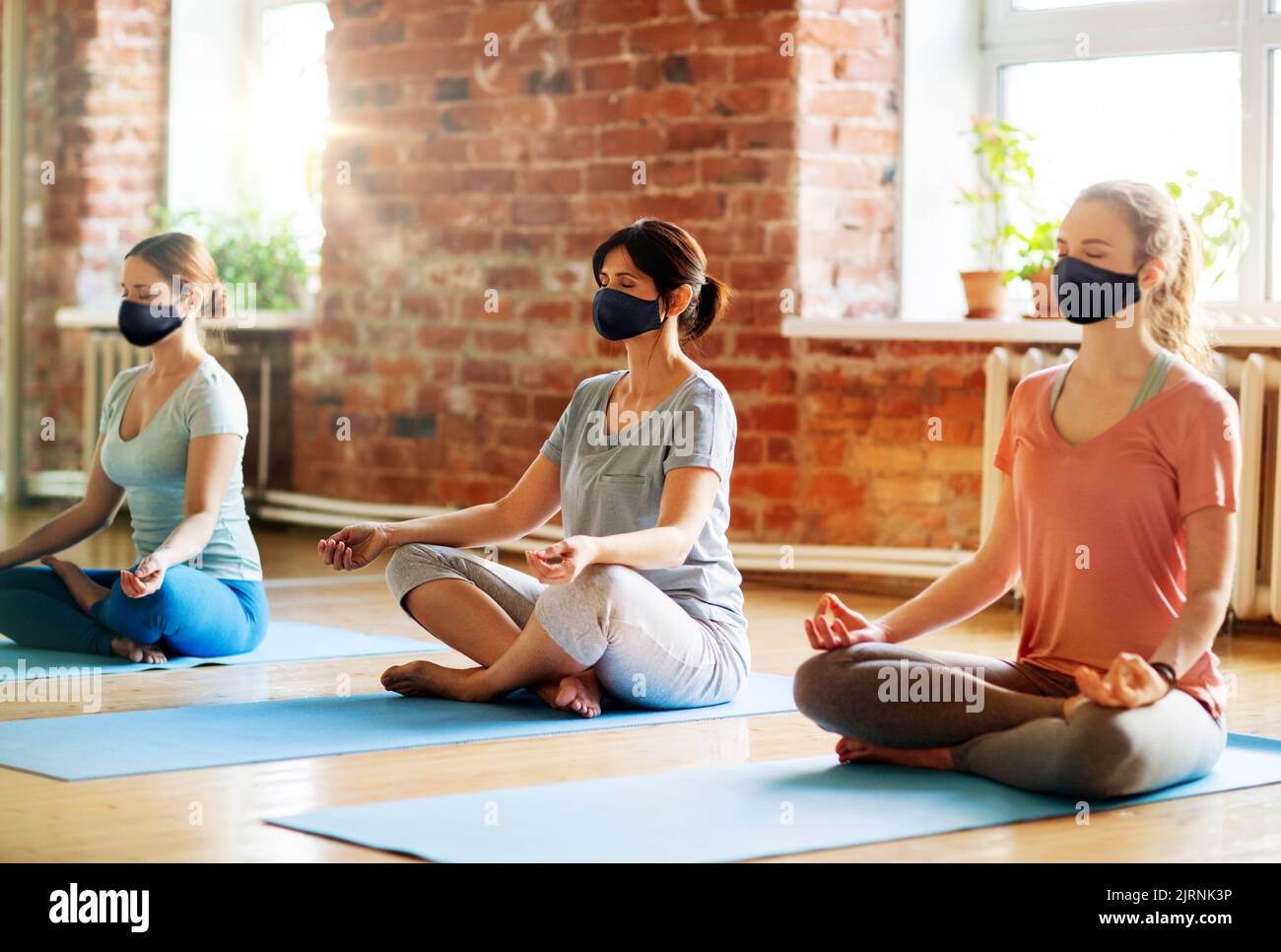 group of women in masks doing yoga at studio Stock Photo Alamy