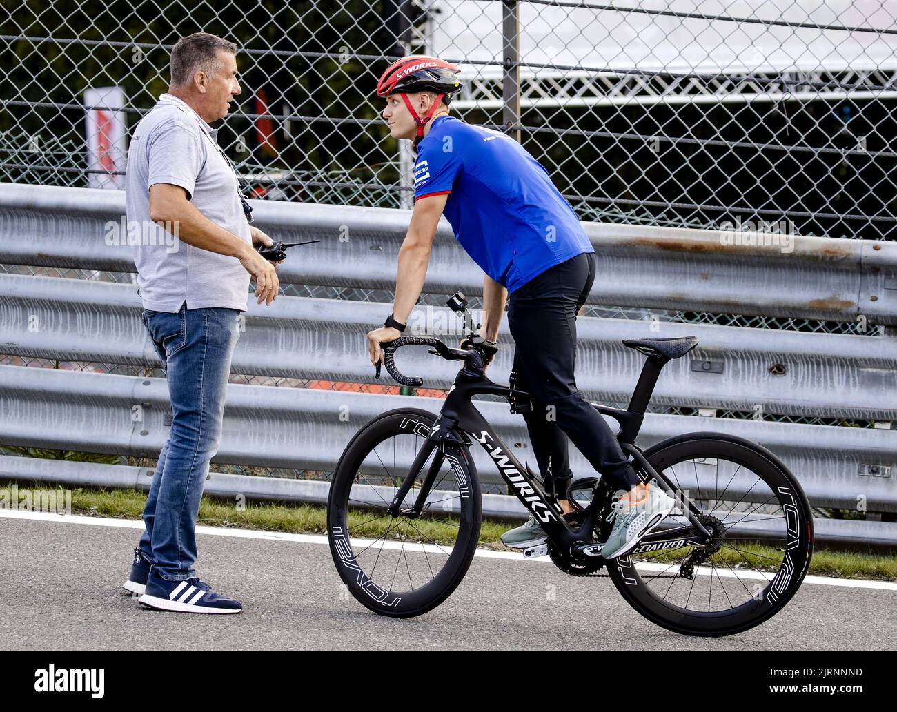 2022-08-25 18:10:22 SPA - Mick Schumacher (Haas F1 Team) is stopped by a security guard at the Spa-Francorchamps race track in the run-up to the Belgian Grand Prix. ANP SEM VAN DER WAL netherlands out - belgium out Stock Photo