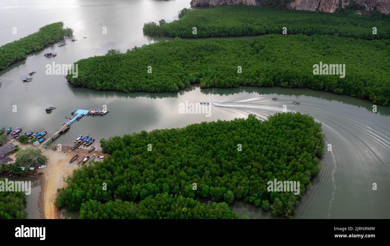 Aerial view of Thai traditional longtail fishing boats at the pier in Phang Nga Bay in the Andaman Sea, Thailand. Top view of many fishing boats float Stock Photo