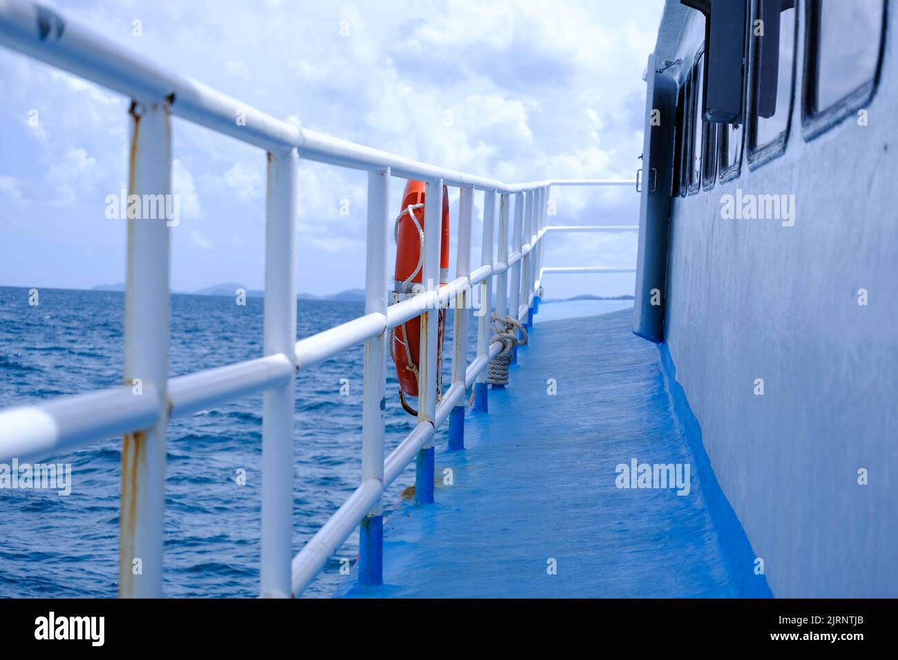 The deck of the ferry sails across the Andaman Sea on a hot summer day. Tropical sea views from the passenger ferry deck. Travel and transportation co Stock Photo