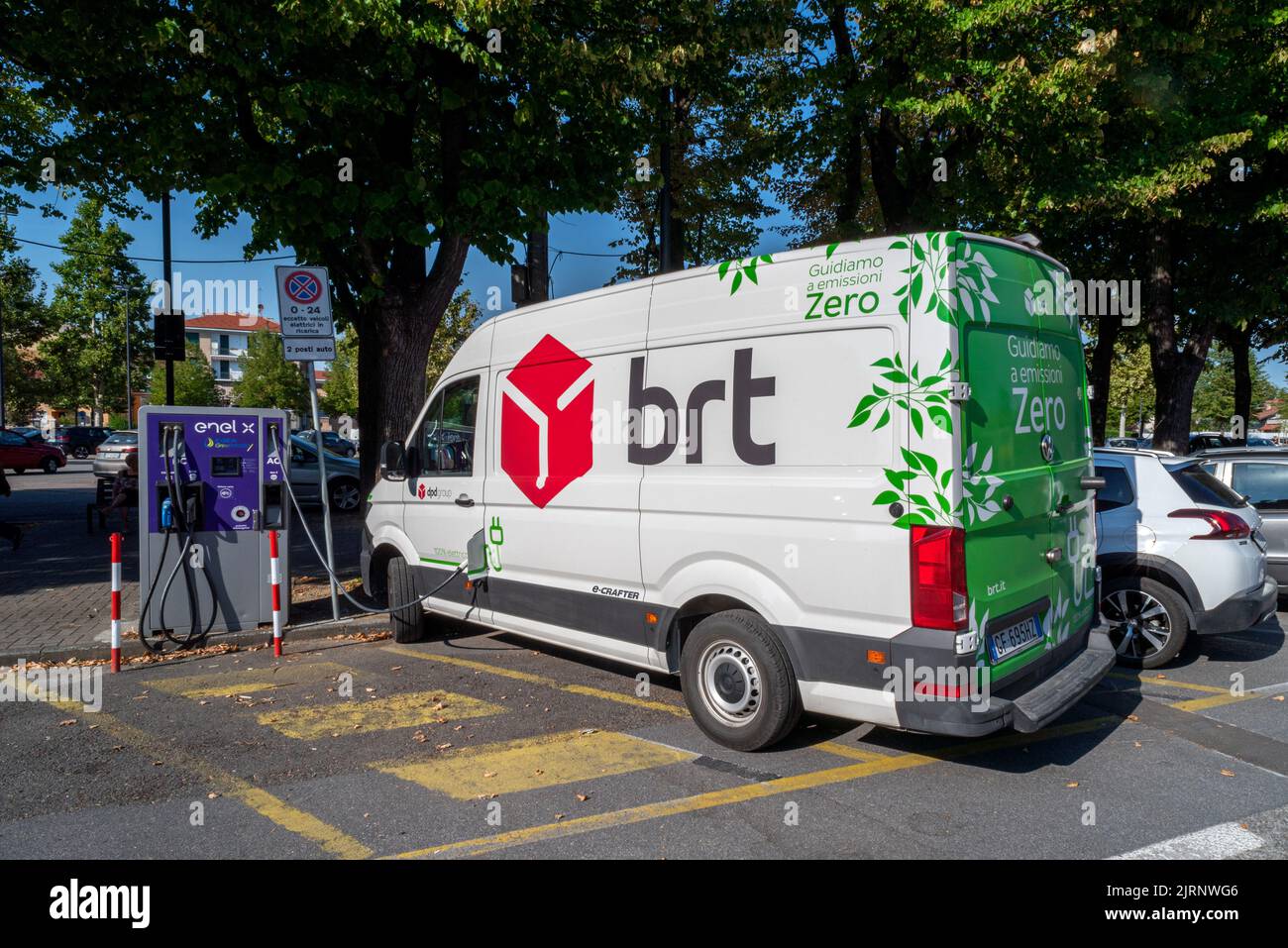 Fossano, Italy - August 25, 2022: Brt express courier electric van charging from the Enel charging column. Brt is italian Leading company for transpor Stock Photo