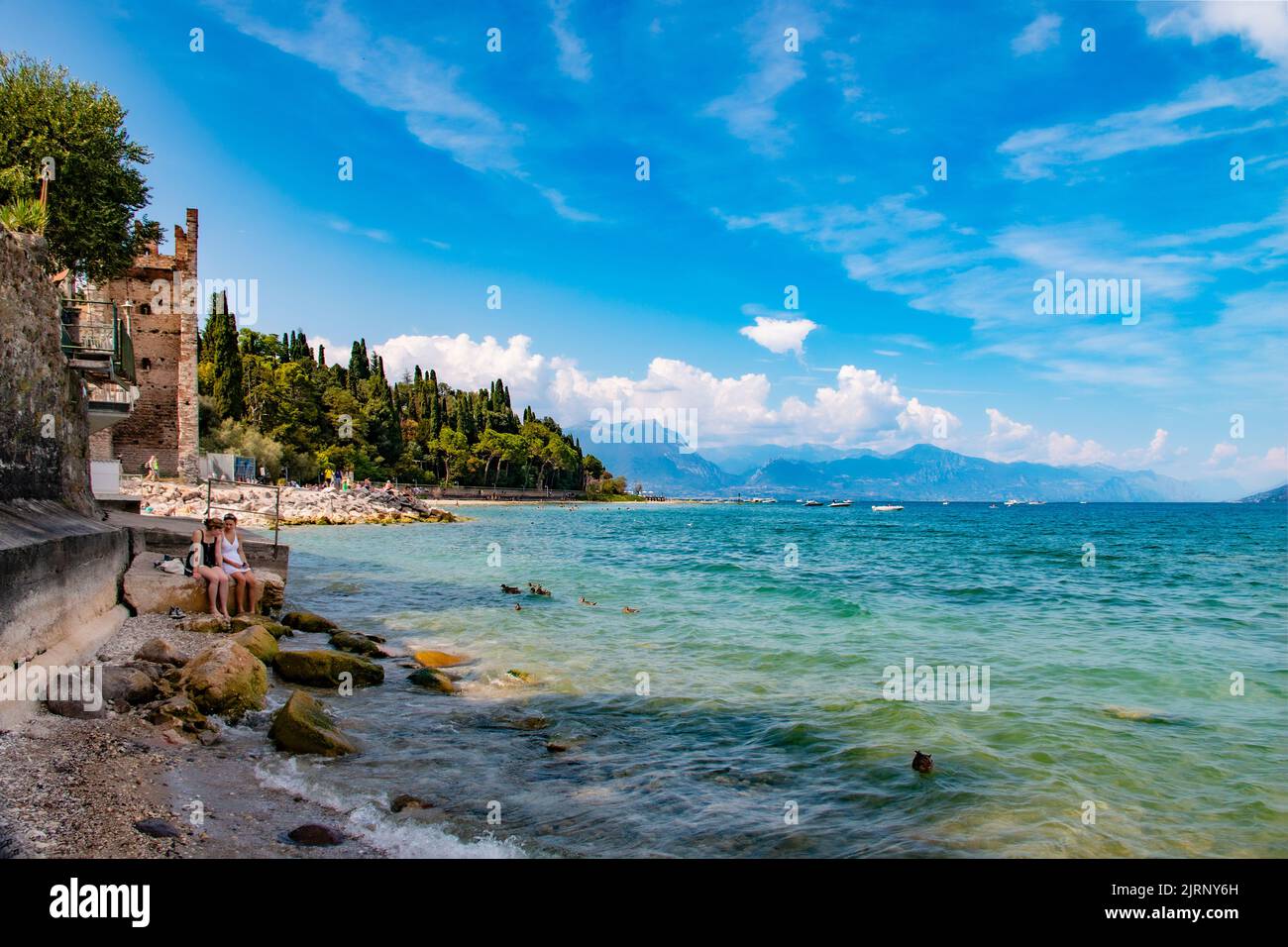 Beautiful colours of Lake Garda from Spiaggia del prete beach, Sirmione, Brescia, Italy Stock Photo