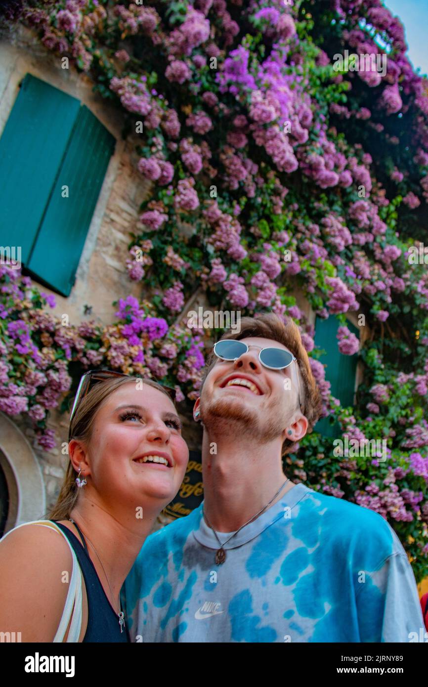 Happy young tourist couple on honeymoon in romantic Sirmione, on Lake Garda, Brescia, Italy Stock Photo