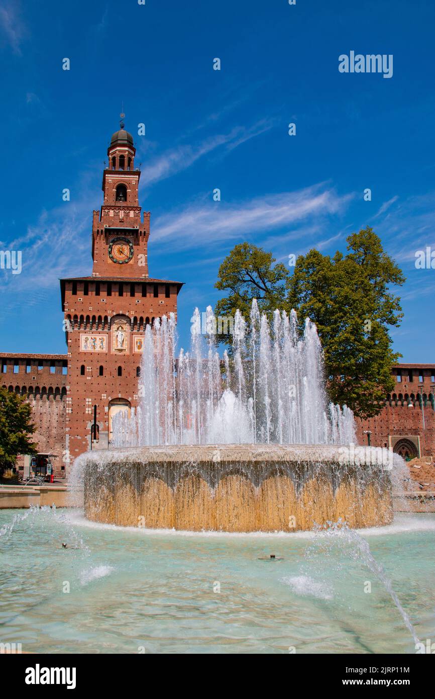 Beautiful Piazza Castello Fountain, Fontana di Piazza Castello, and Il Filarete Tower at Sforzesco Castle, Milan, Lombardy, Italy Stock Photo