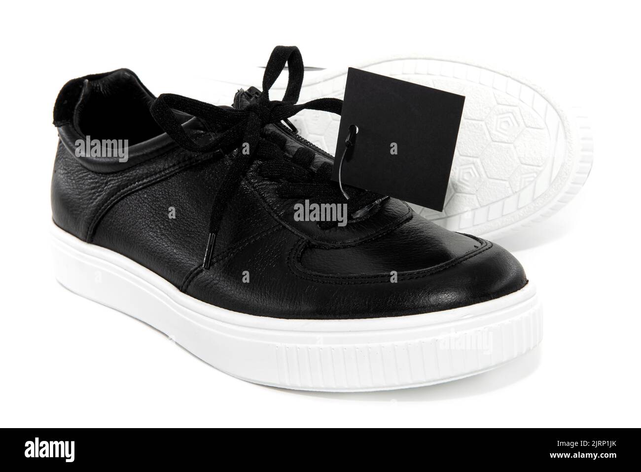 Men's black boots with a white sole on a white background. Shoes isolate with price tag for inscription Stock Photo