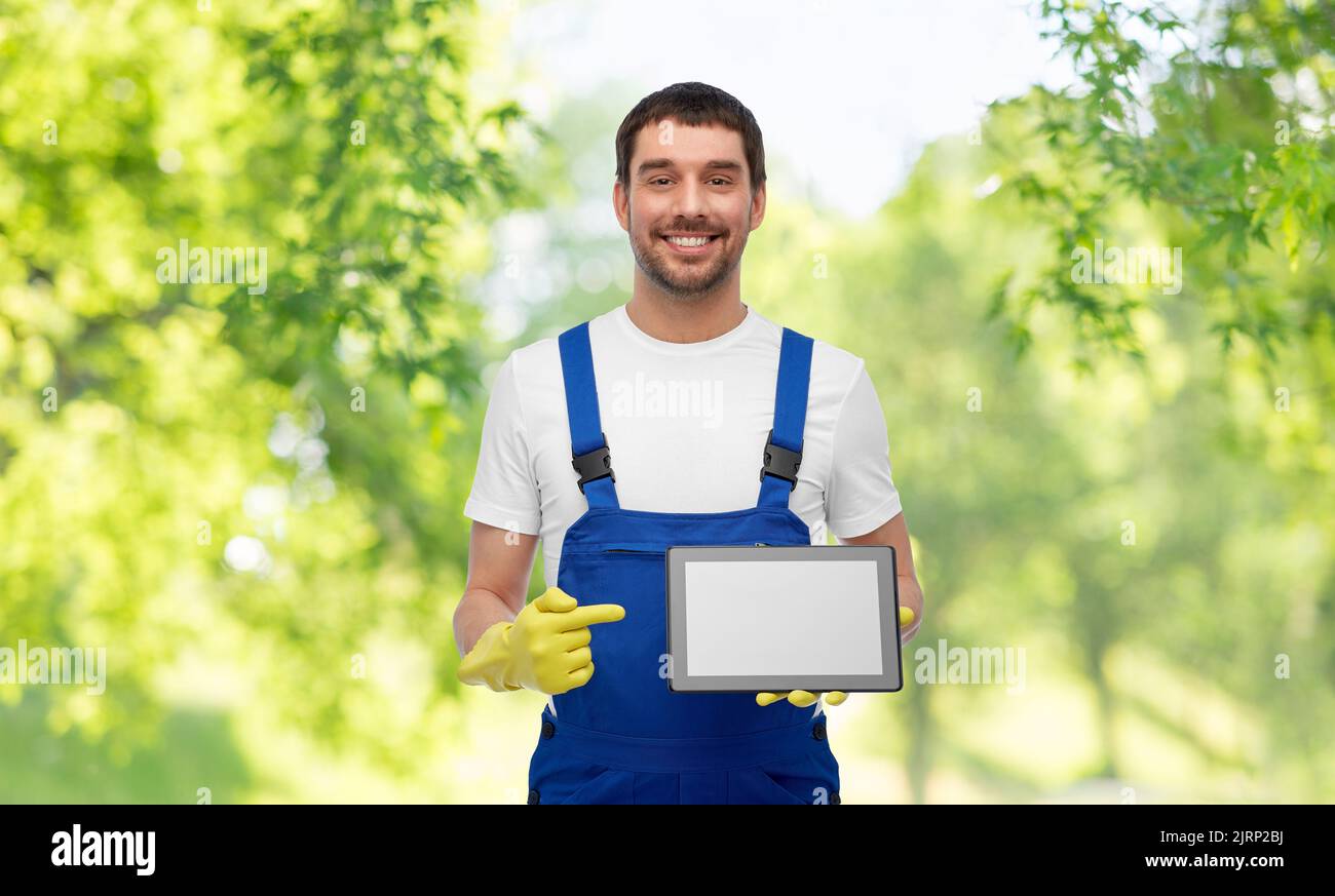 happy male worker or cleaner showing tablet pc Stock Photo