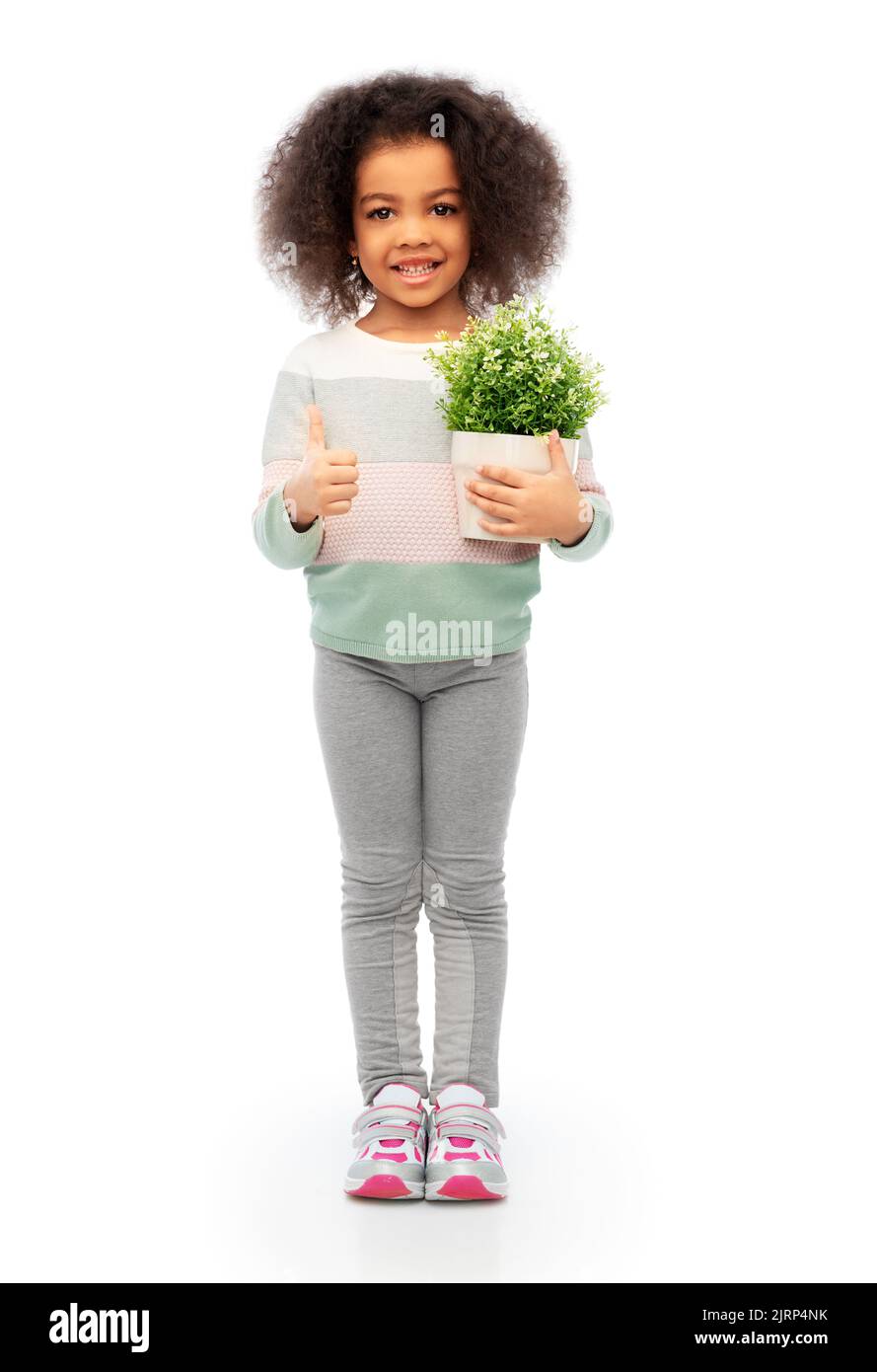 smiling girl holding flower and showing thumbs up Stock Photo - Alamy