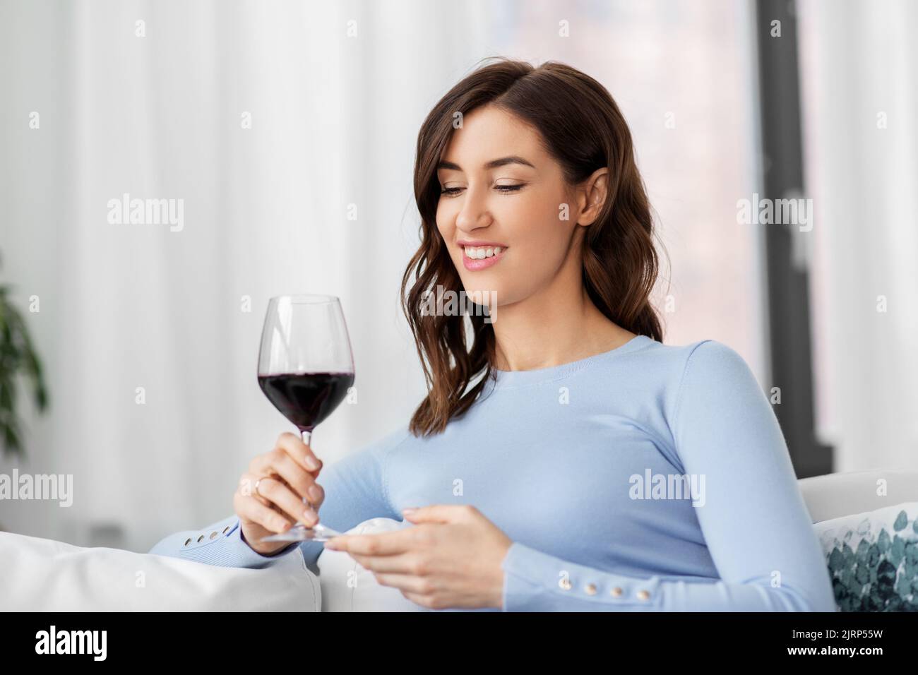 happy woman drinking red wine at home Stock Photo - Alamy