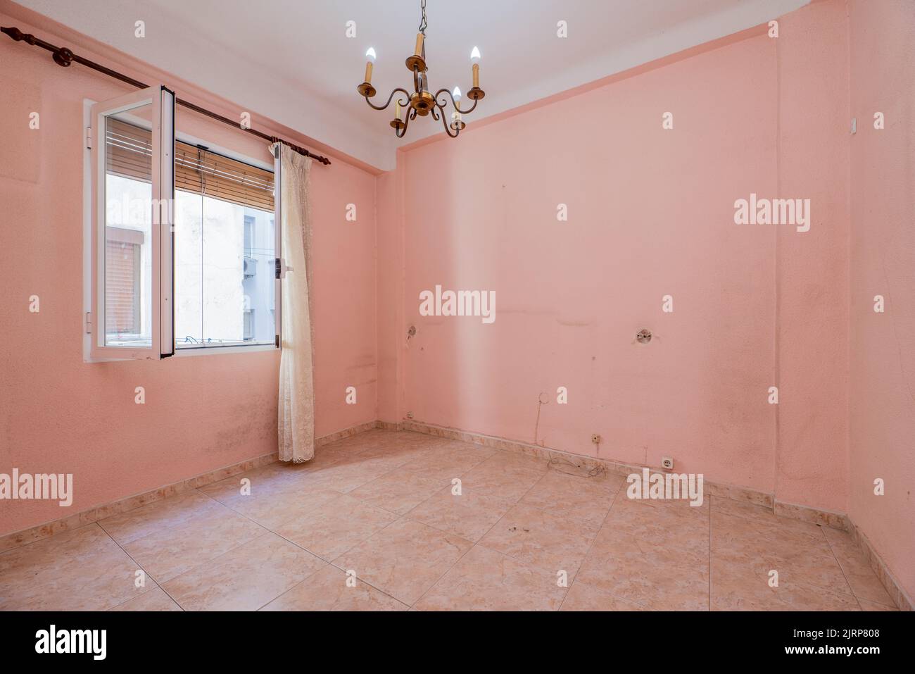 Empty room with pink painted walls, matching stoneware floors and white aluminum window Stock Photo