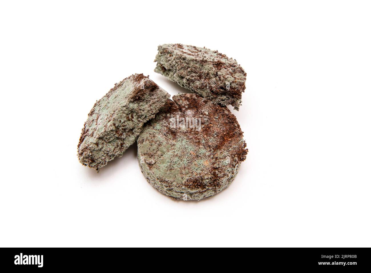 The three mouldy grounded coffee capsules from the coffee machine because of bad cleaning or forgotten. Stock Photo
