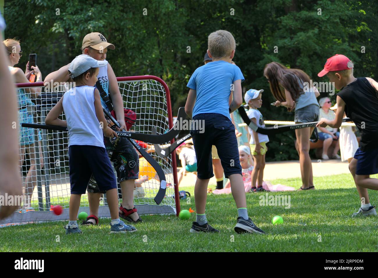 Nizhny Novgorod, Russia. switzerland park, 08.06.2022. Children play field hockey in the park in summer. High quality photo Stock Photo