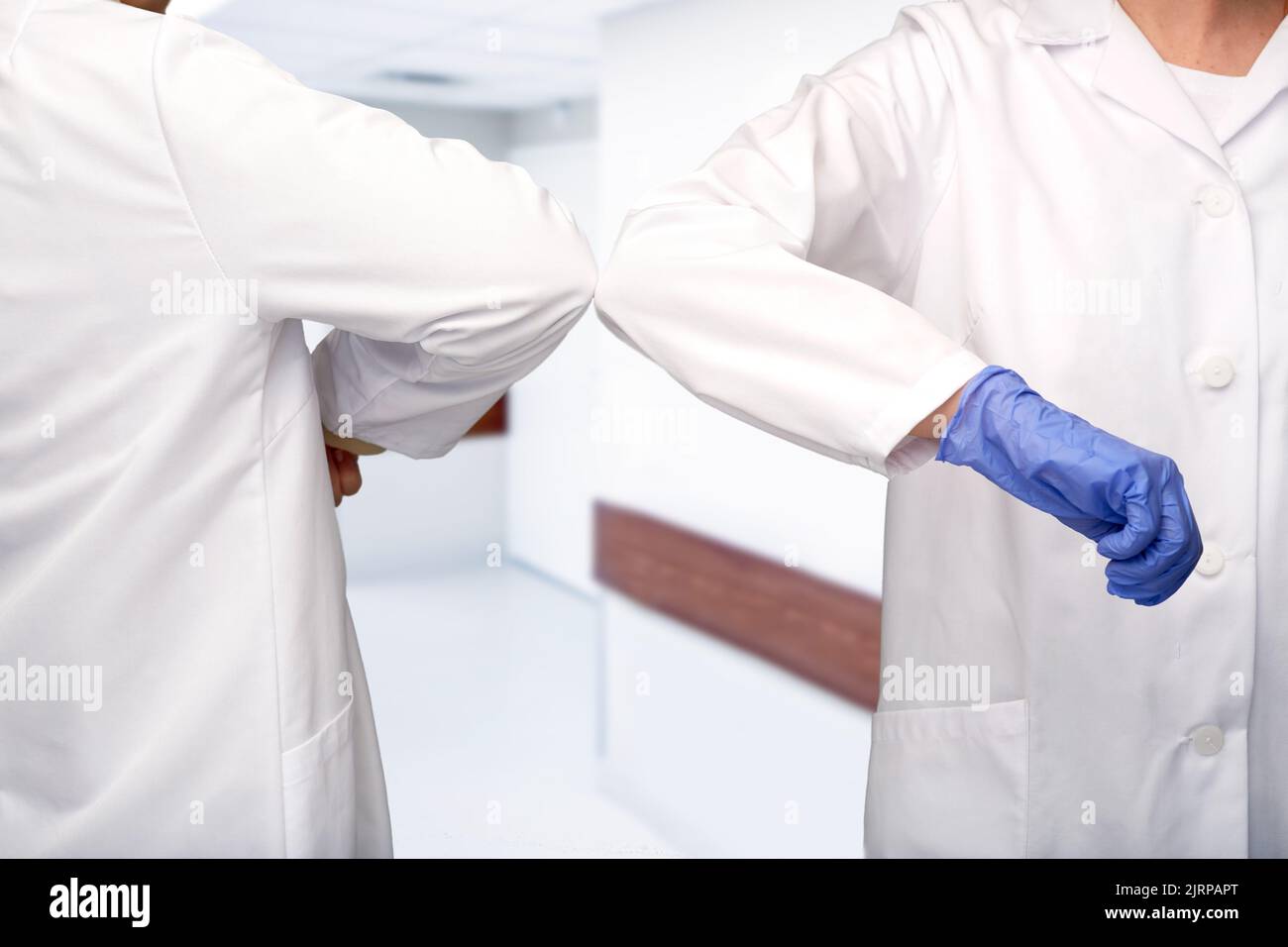 close up of doctors make elbow bump gesture Stock Photo
