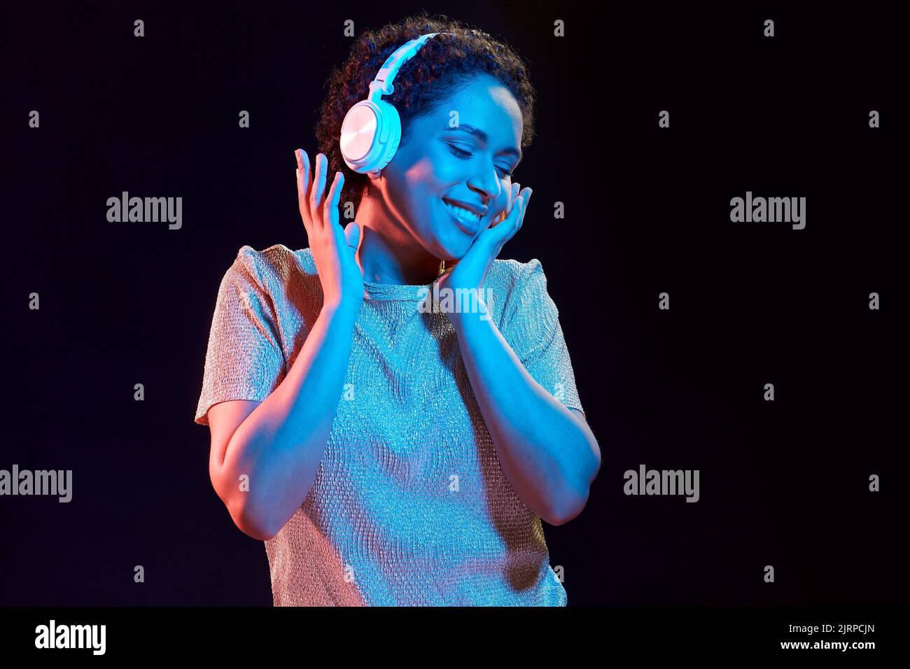 woman in headphones listening to music and dancing Stock Photo - Alamy
