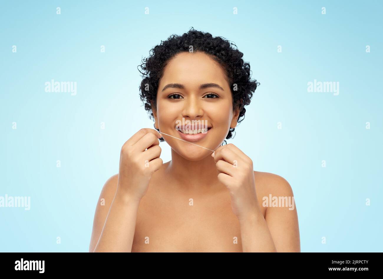 african woman cleaning teeth with dental floss Stock Photo Alamy