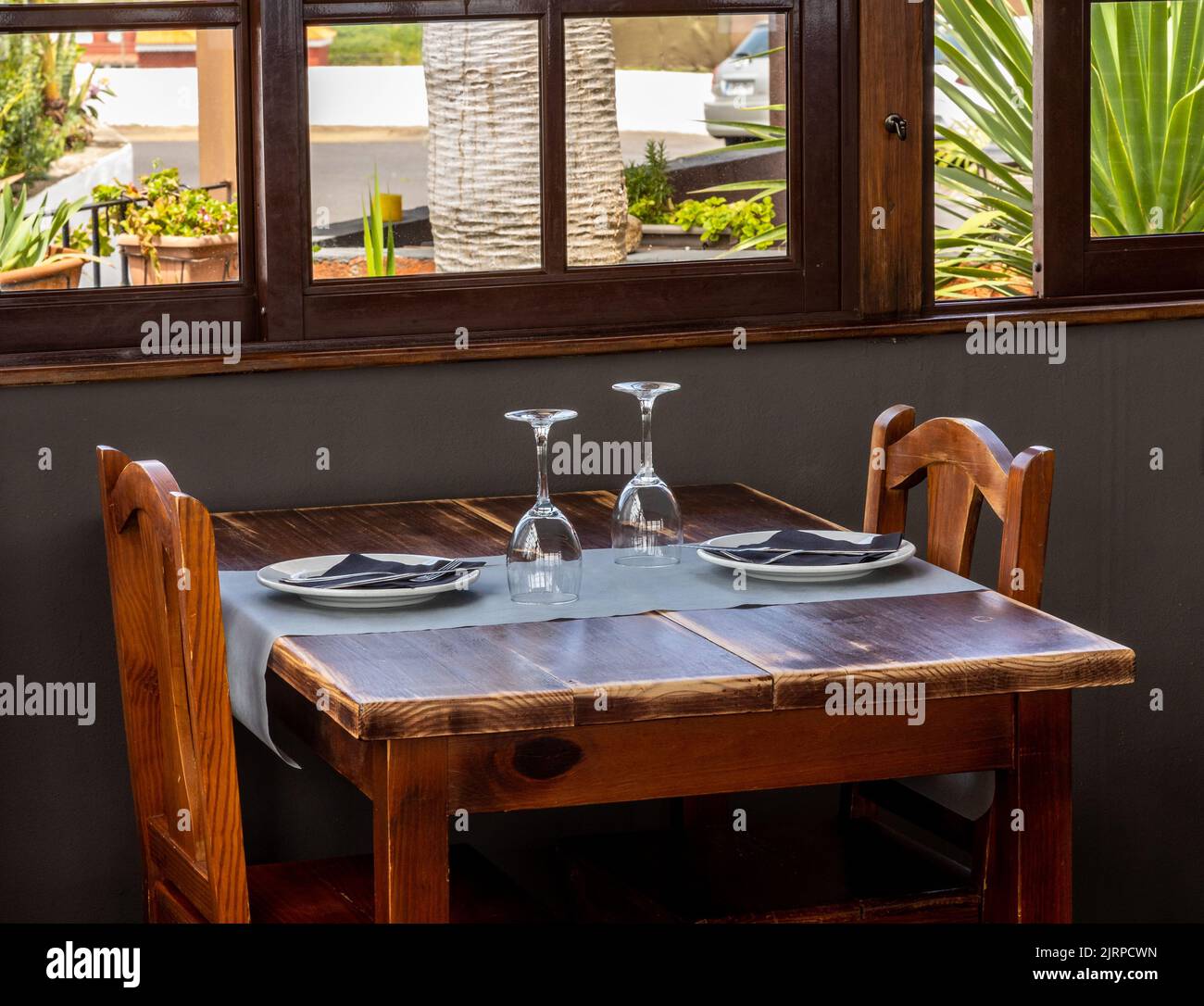 A view of a table with wooden chairs in a cafe Stock Photo - Alamy