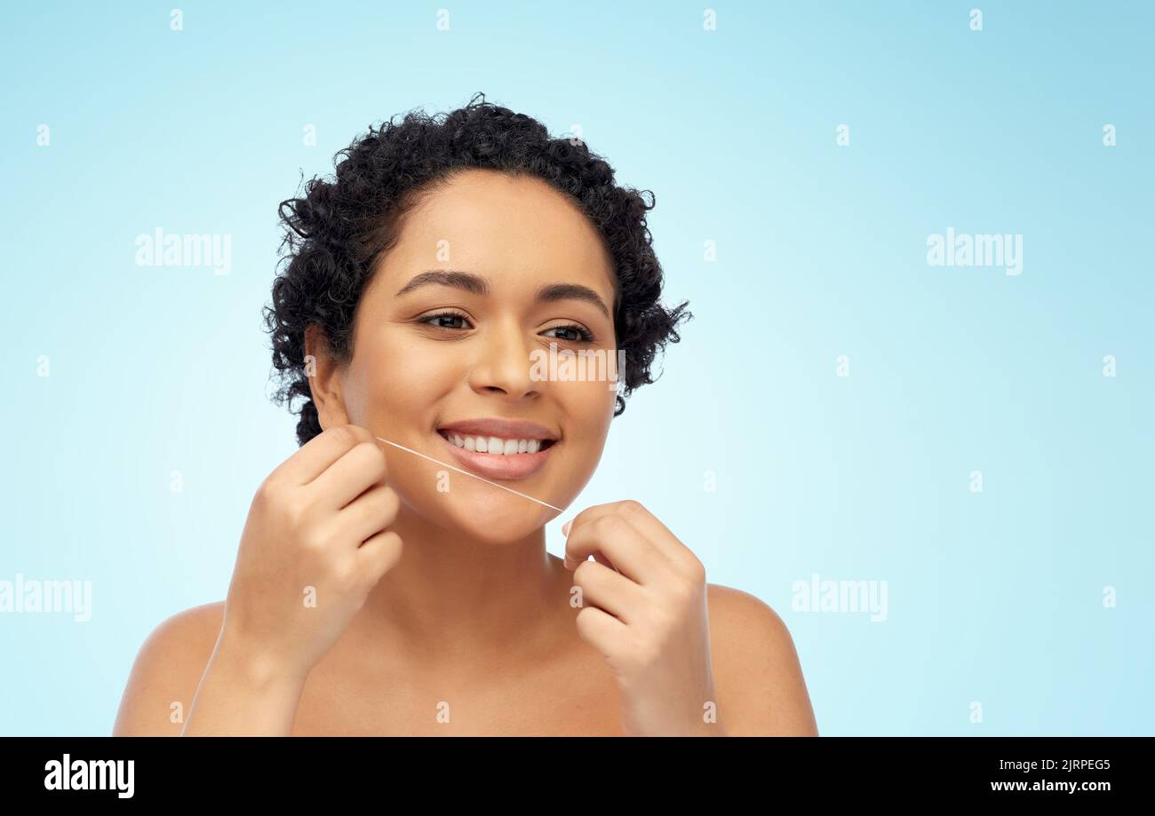 african woman cleaning teeth with dental floss Stock Photo Alamy