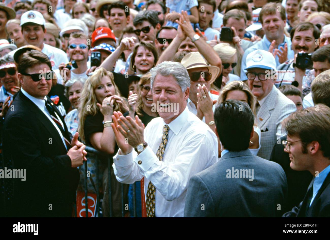 U.S. President Bill Clinton steps into the crowd to take a selfie with crowds of supporters during a campaign rally outside the Stafford Public Library, August 30, 1996 in Cairo, Illinois. Clinton stopped in the Southern Illinois farming community on his campaign bus tour named the bridge to the 21st century. Stock Photo