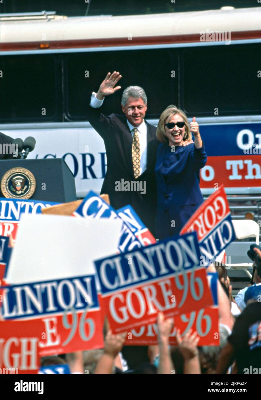 U.S. President Bill Clinton and First Lady Hillary Clinton wave to crowds of supporters during a campaign rally, August 30, 1996 in Cape Girardeau, Missouri. Clinton stopped in the Mississippi River community on his campaign bus tour named the bridge to the 21st century. Stock Photo