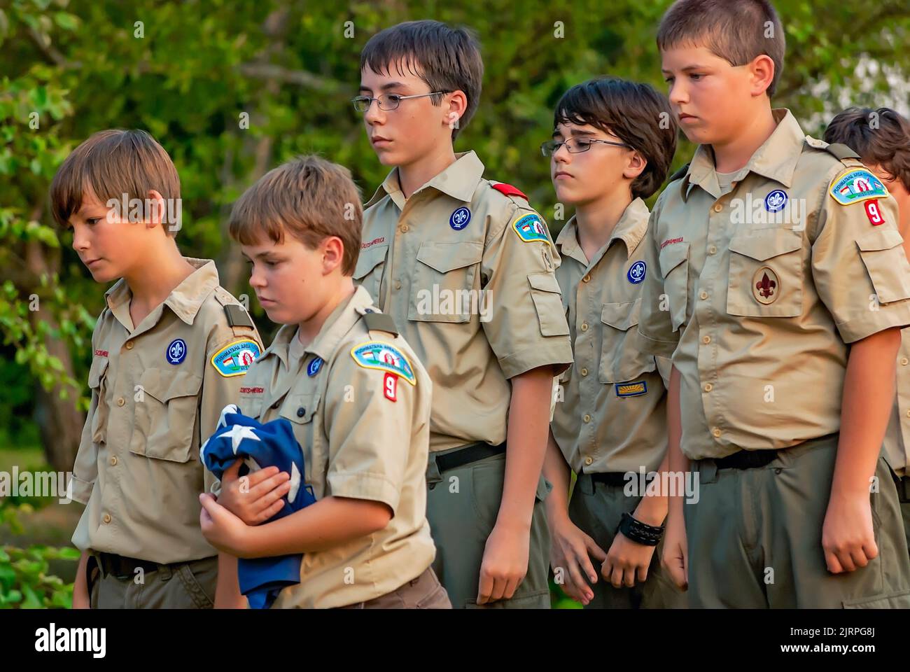Boy Scouts carry American flags to be burned in a flag retirement