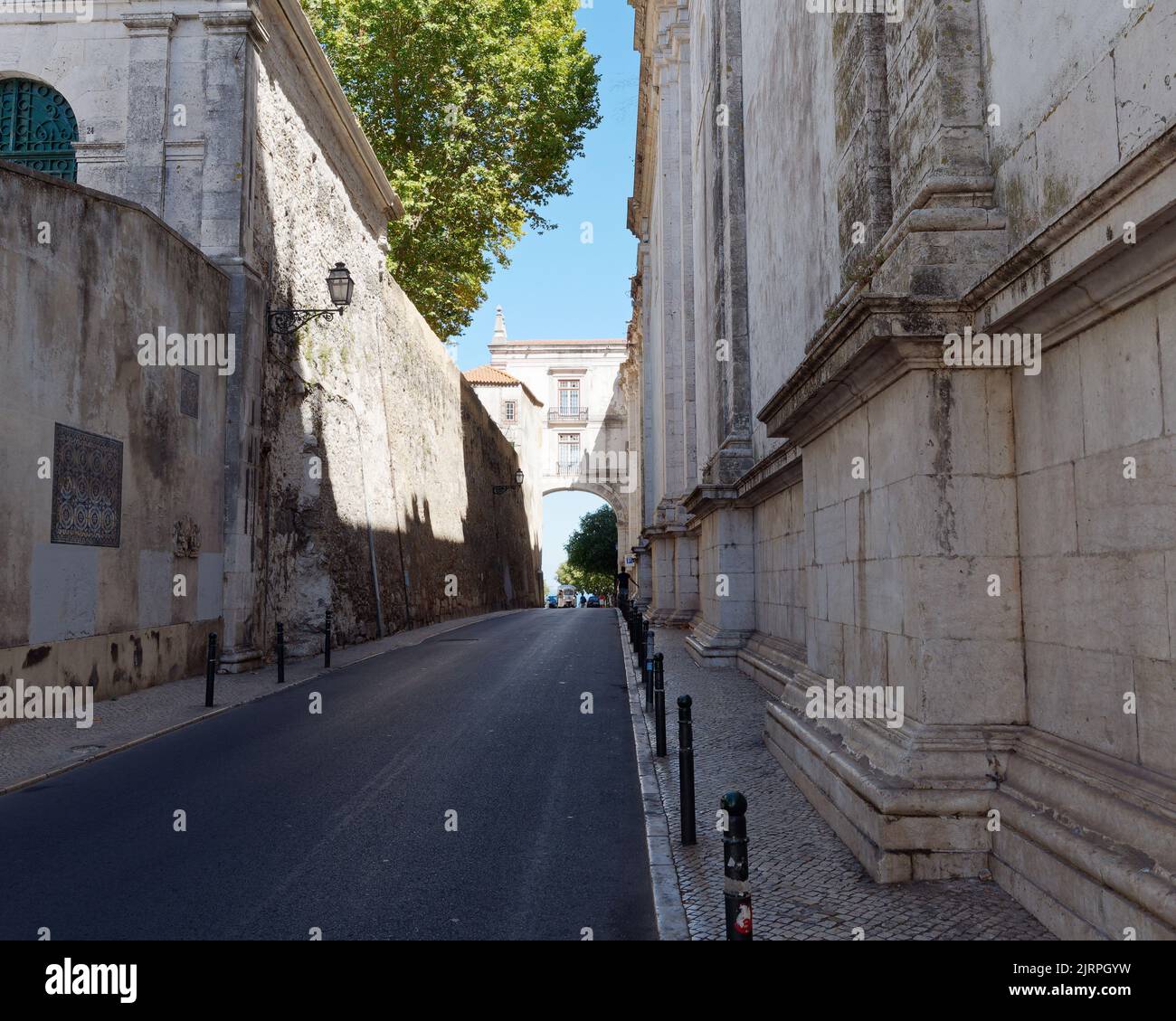 Road with quaint arch connecting the  Monastery of São Vicente de Fora (Monastery of Saint Vincent Outside the Walls) on the right. Lisbon, Portugal. Stock Photo