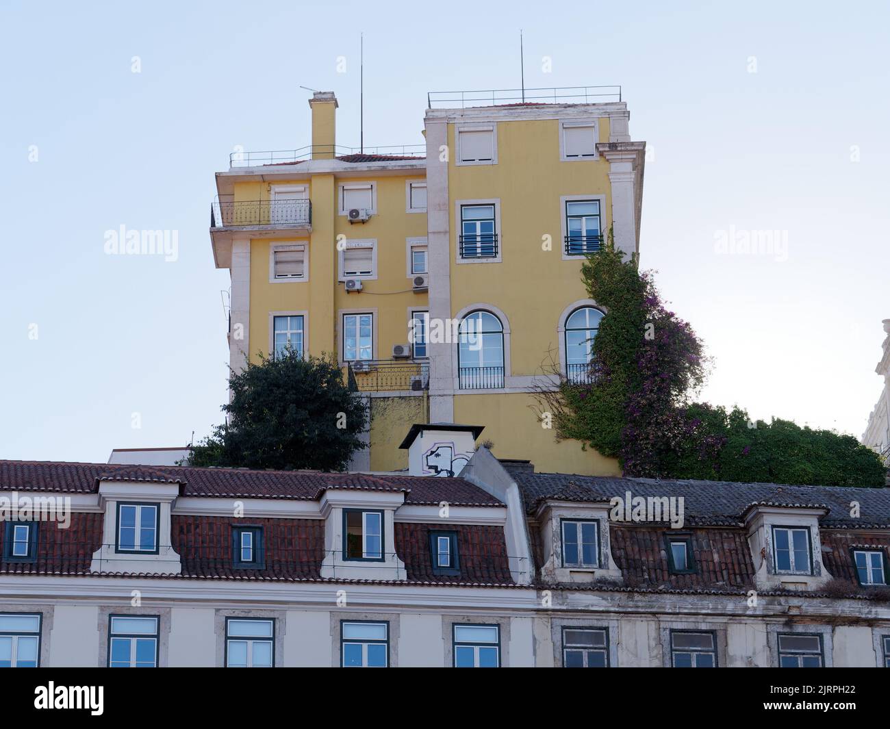 Yellow buildings overlooking praça do município (Municipal Square, out of picture), Lisbon, Portugal. Stock Photo