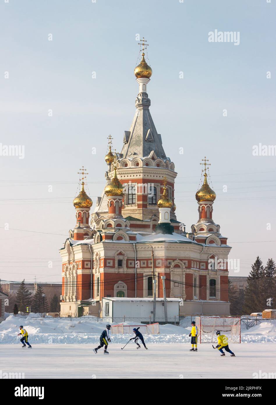 Locals skating next to Uralsk Archangel Michael Cathedral Stock Photo