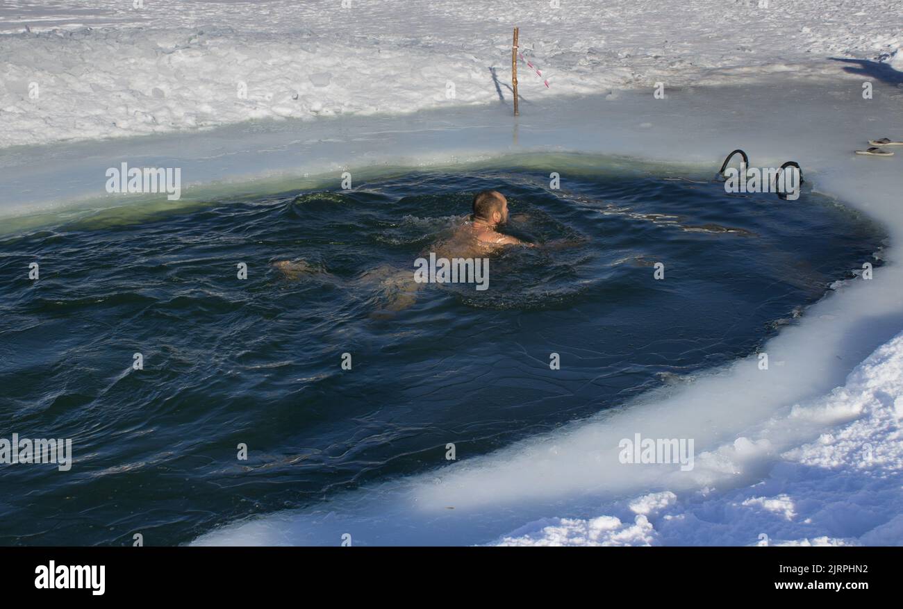 Ice pool swimming in frozen Ural river Stock Photo