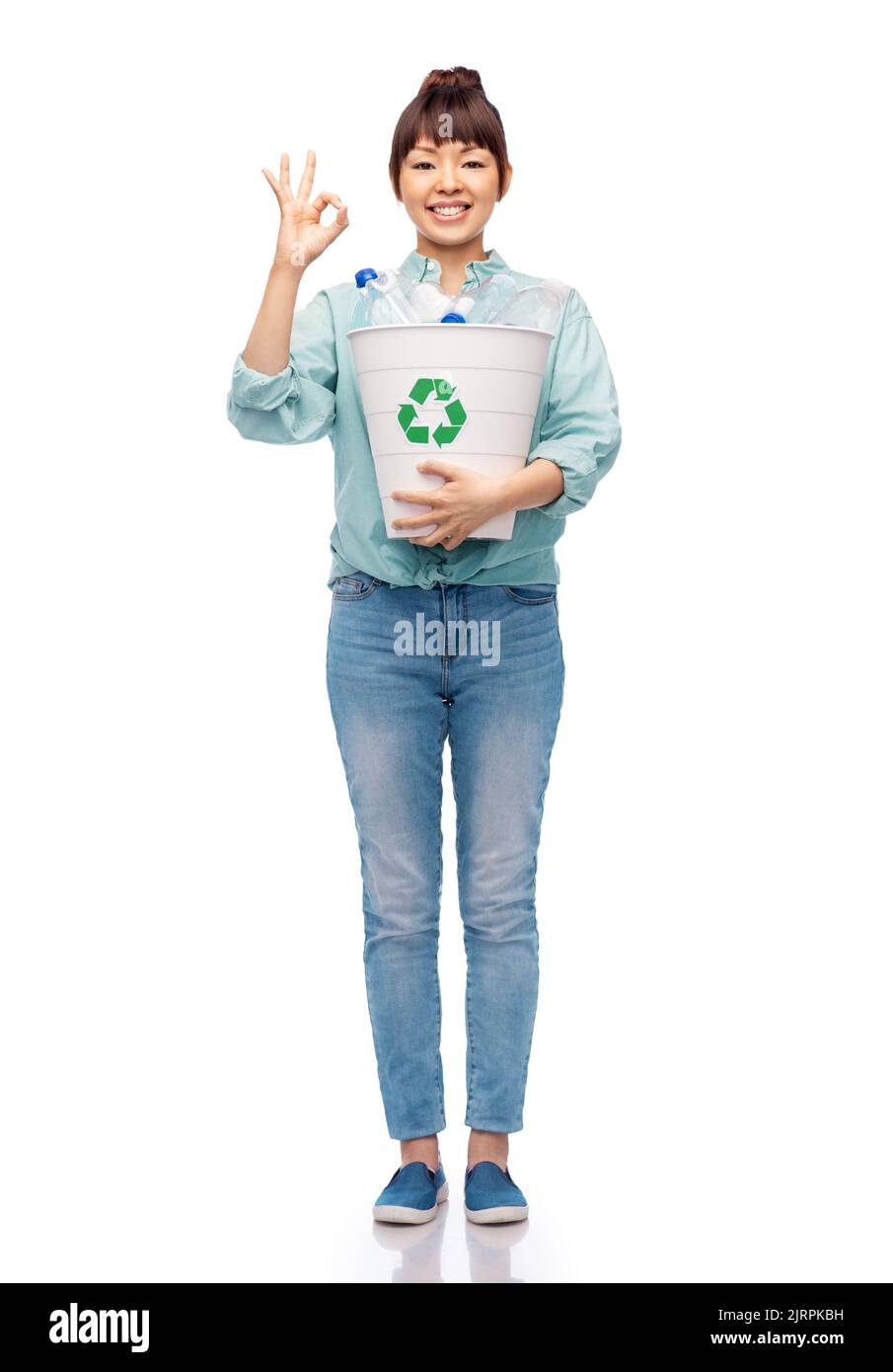 smiling young woman sorting plastic waste Stock Photo