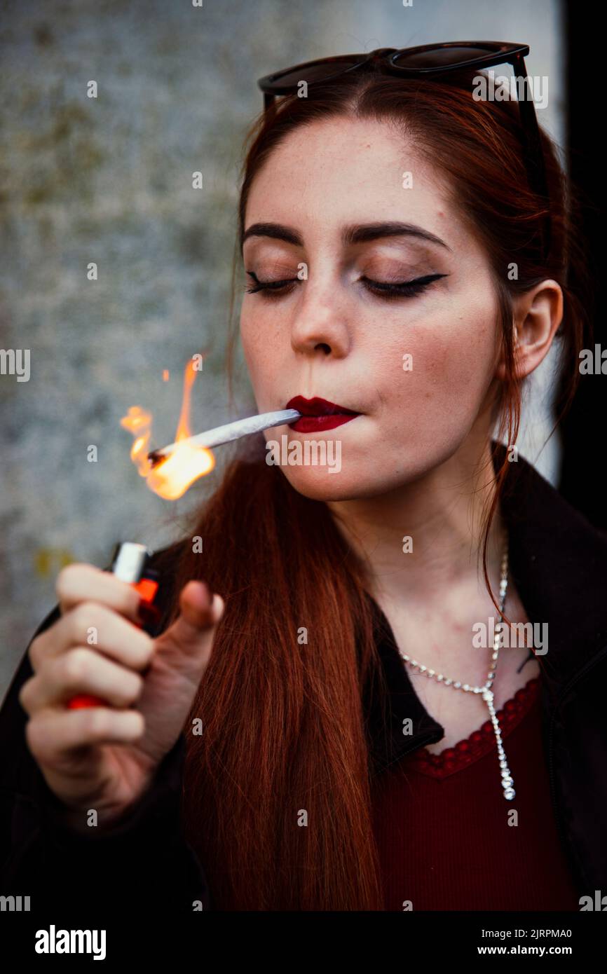 Closeup of a redhaired girl smoking a joint Stock Photo Alamy
