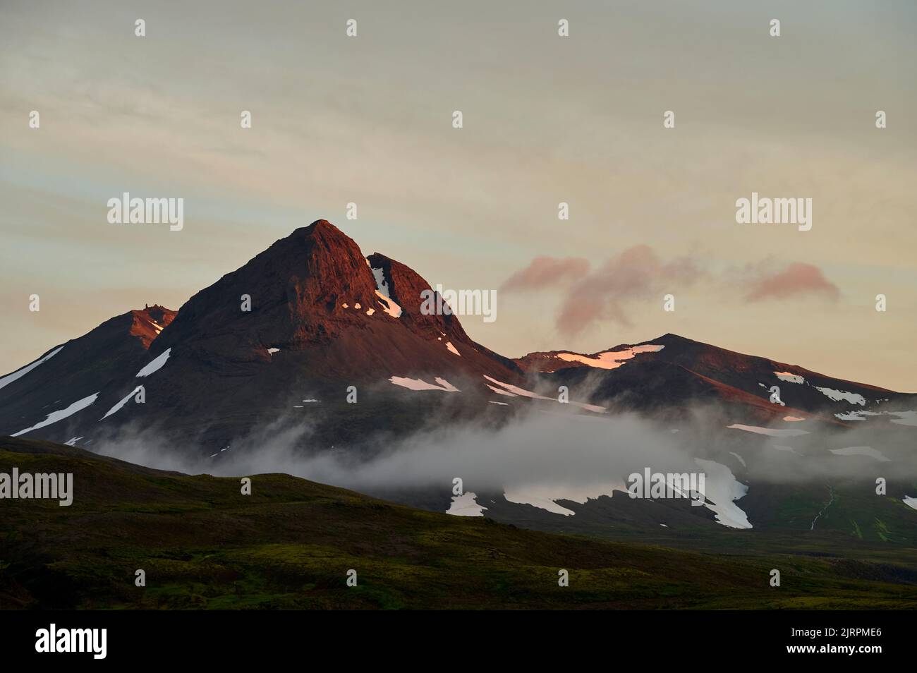 Snowy mountains against sunset sky Stock Photo - Alamy