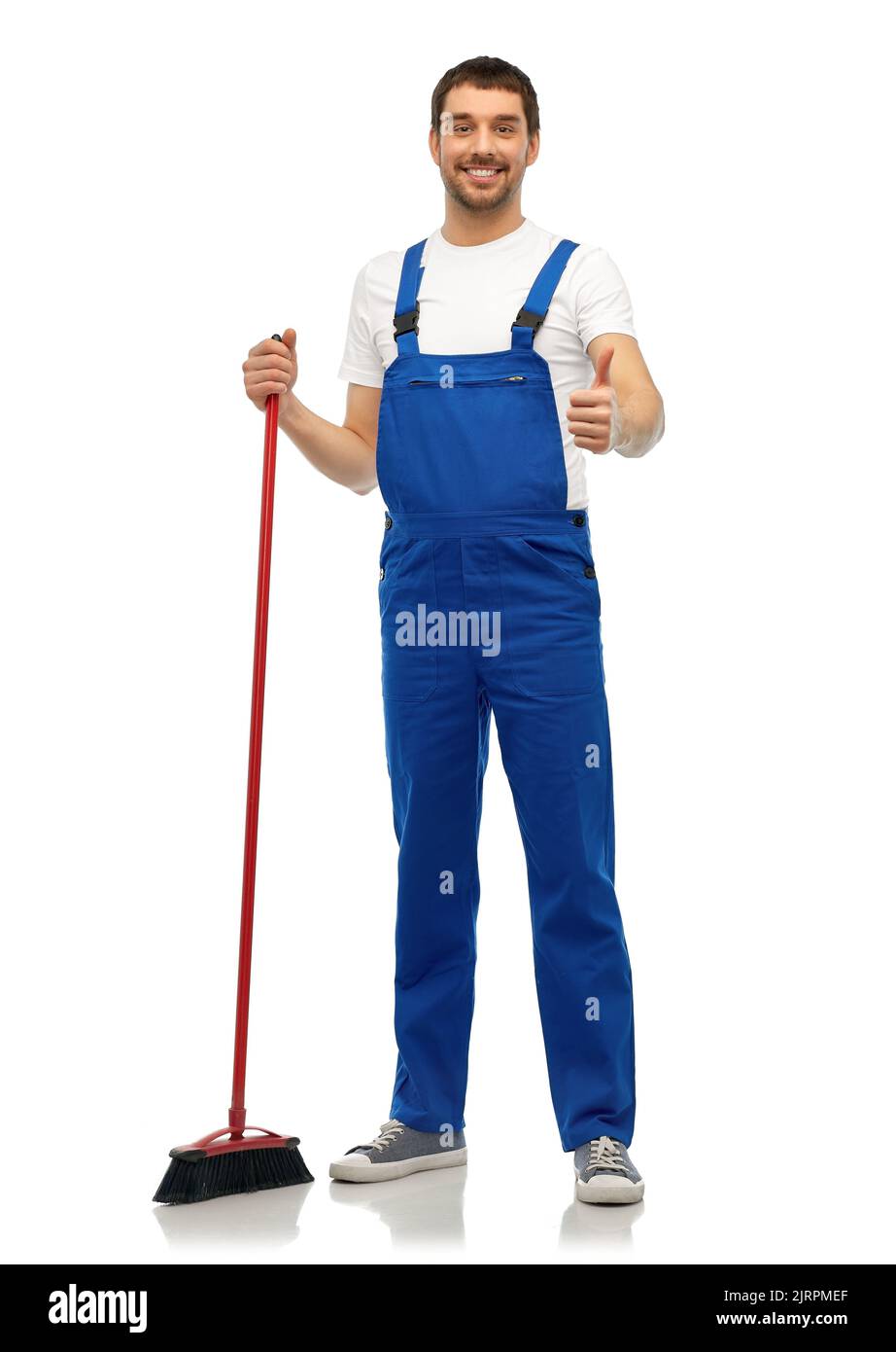 male cleaner in overall cleaning floor with broom Stock Photo Alamy