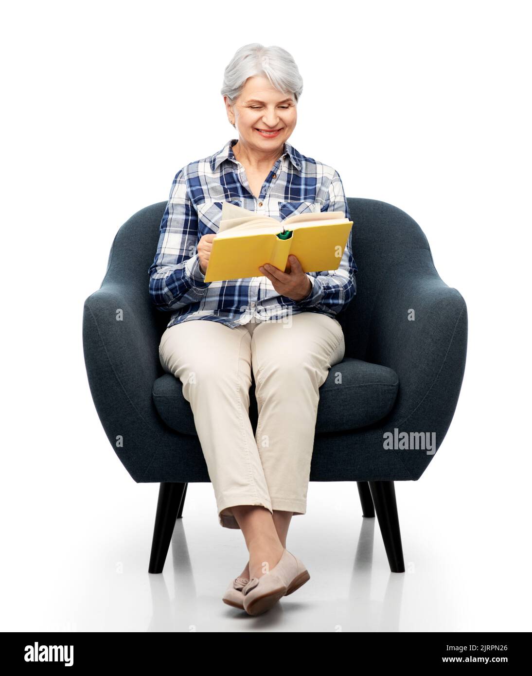 senior woman reading book sitting in armchair Stock Photo - Alamy