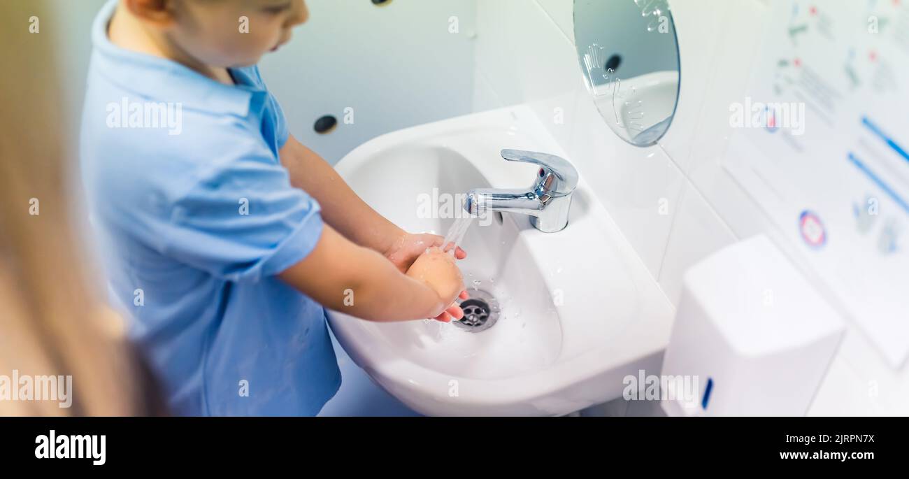 little boy washing his hands at nursery. High quality photo Stock Photo