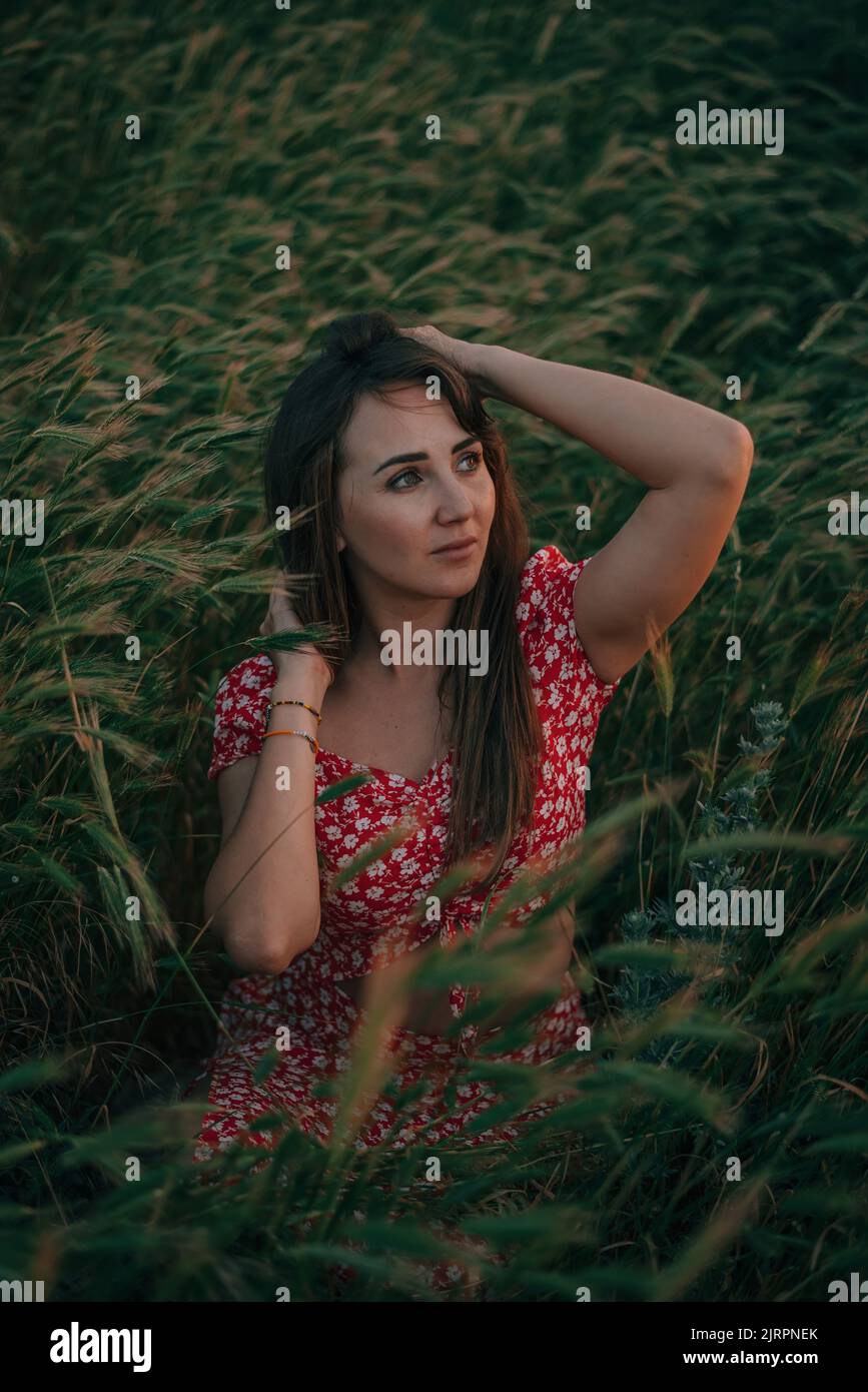 portrait of young woman in summer in tall grass Stock Photo