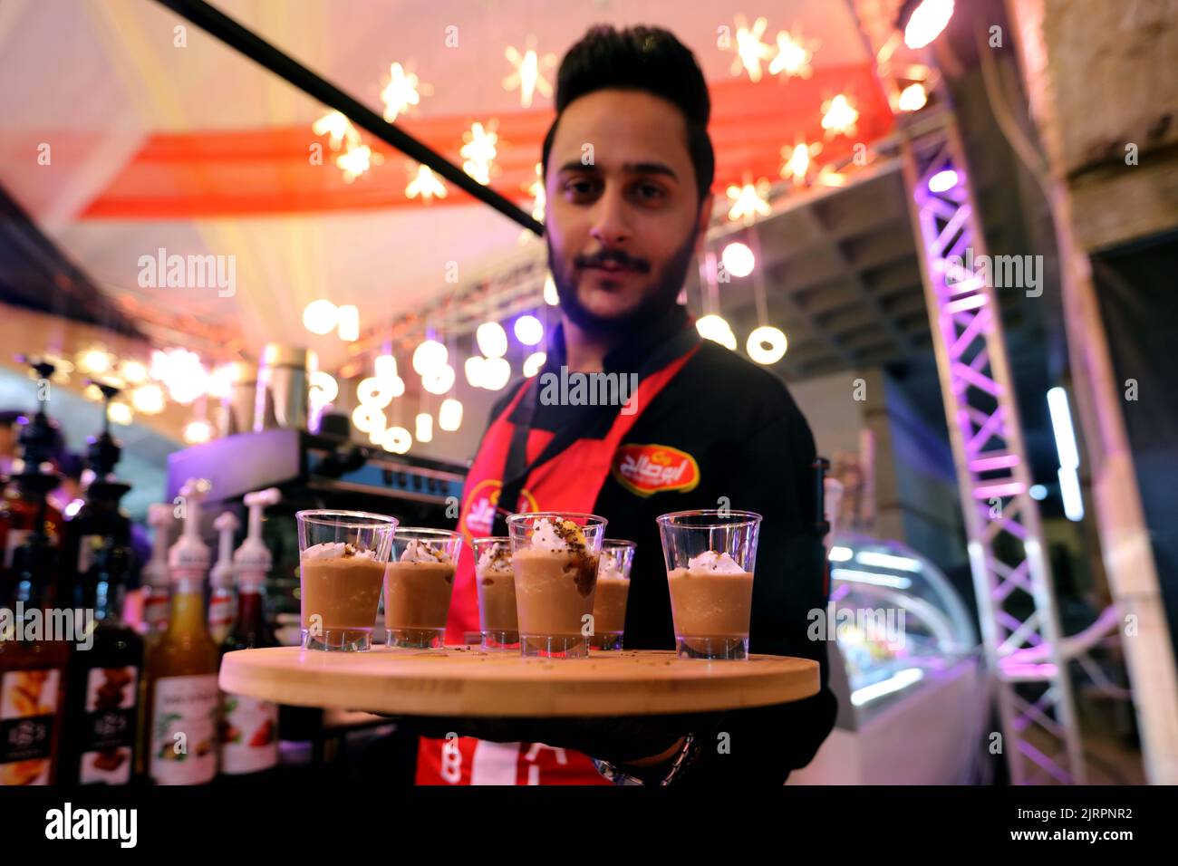 Amman, Jordan. 25th Aug, 2022. A barista prepares coffee for visitors