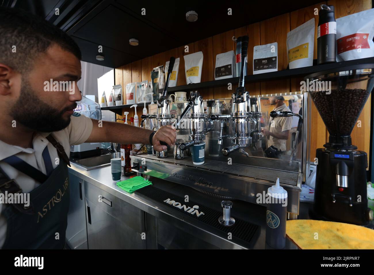 Amman, Jordan. 25th Aug, 2022. A barista prepares coffee for visitors
