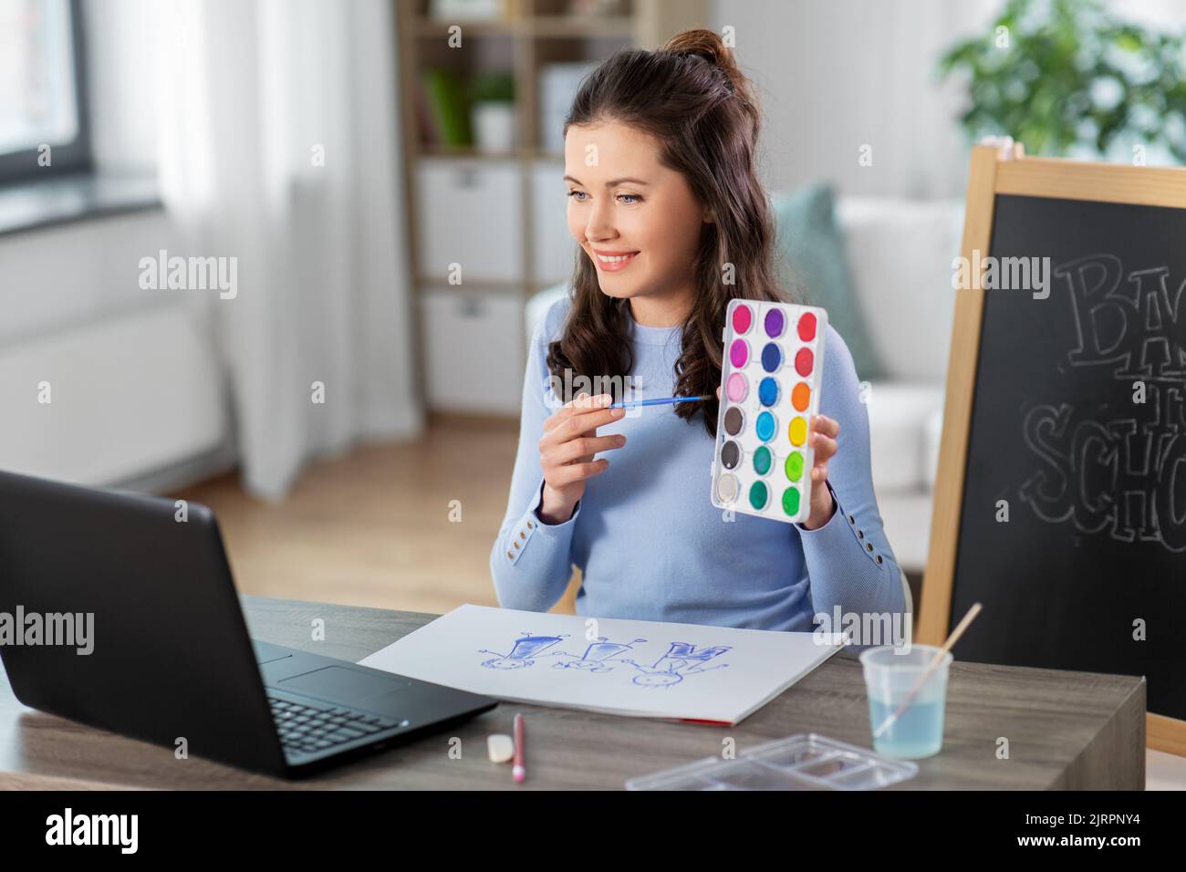 teacher with colors having online class of arts Stock Photo - Alamy