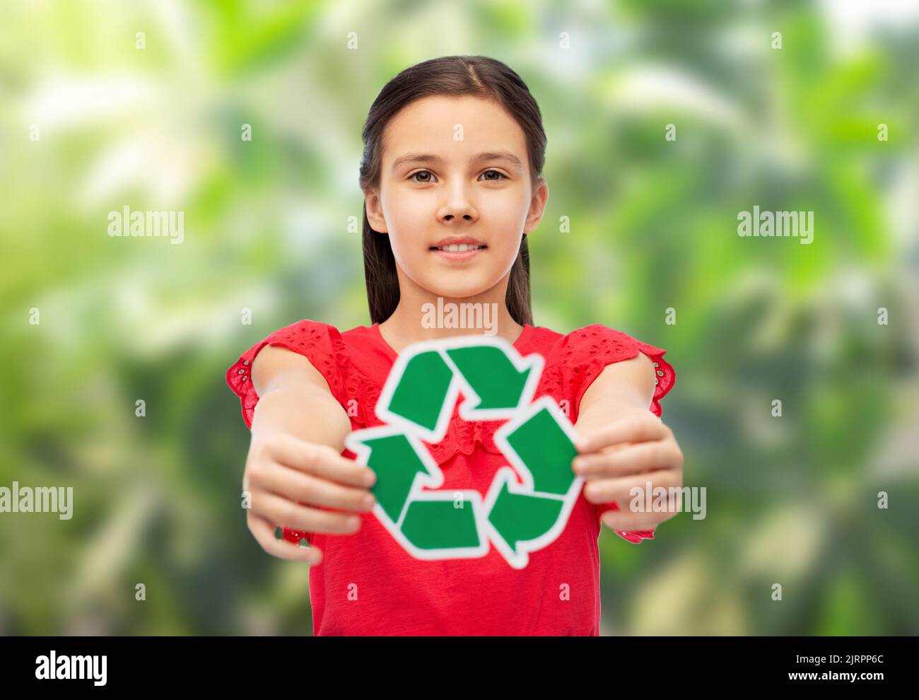 smiling girl holding green recycling sign Stock Photo Alamy