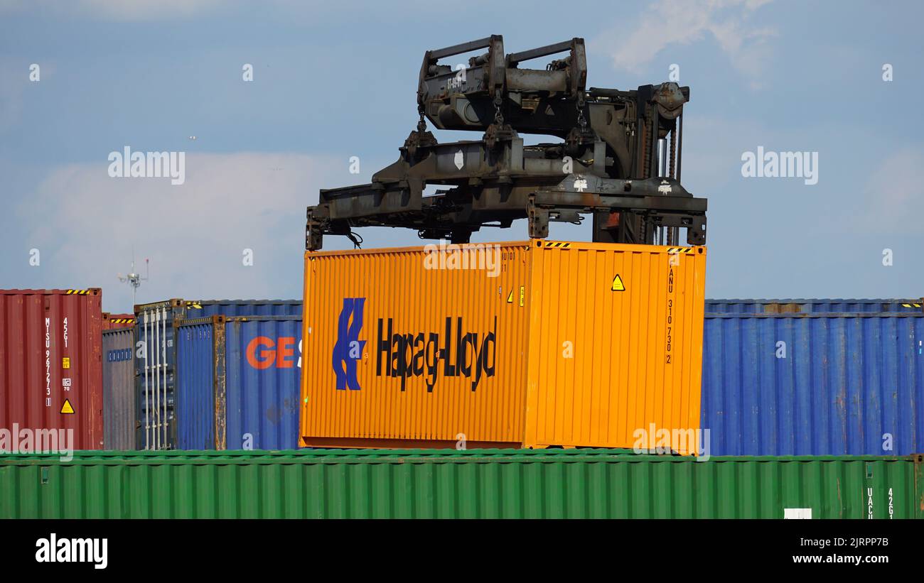 Cargo container being lifted and stacked at a rail yard near Chicago O'Hare International Airport. Stock Photo