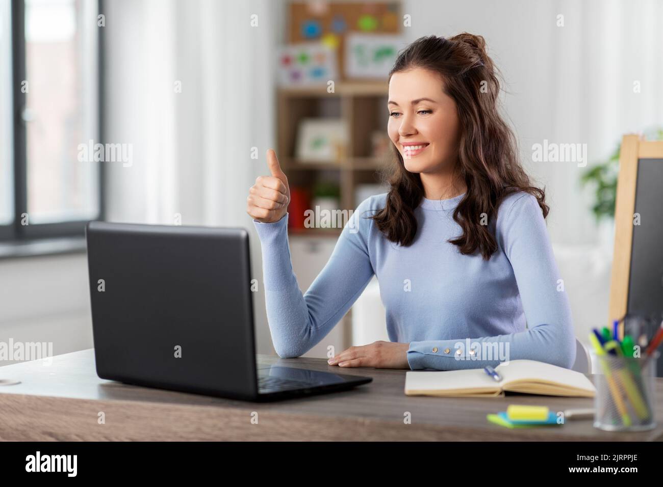teacher with laptop having online class at home Stock Photo - Alamy