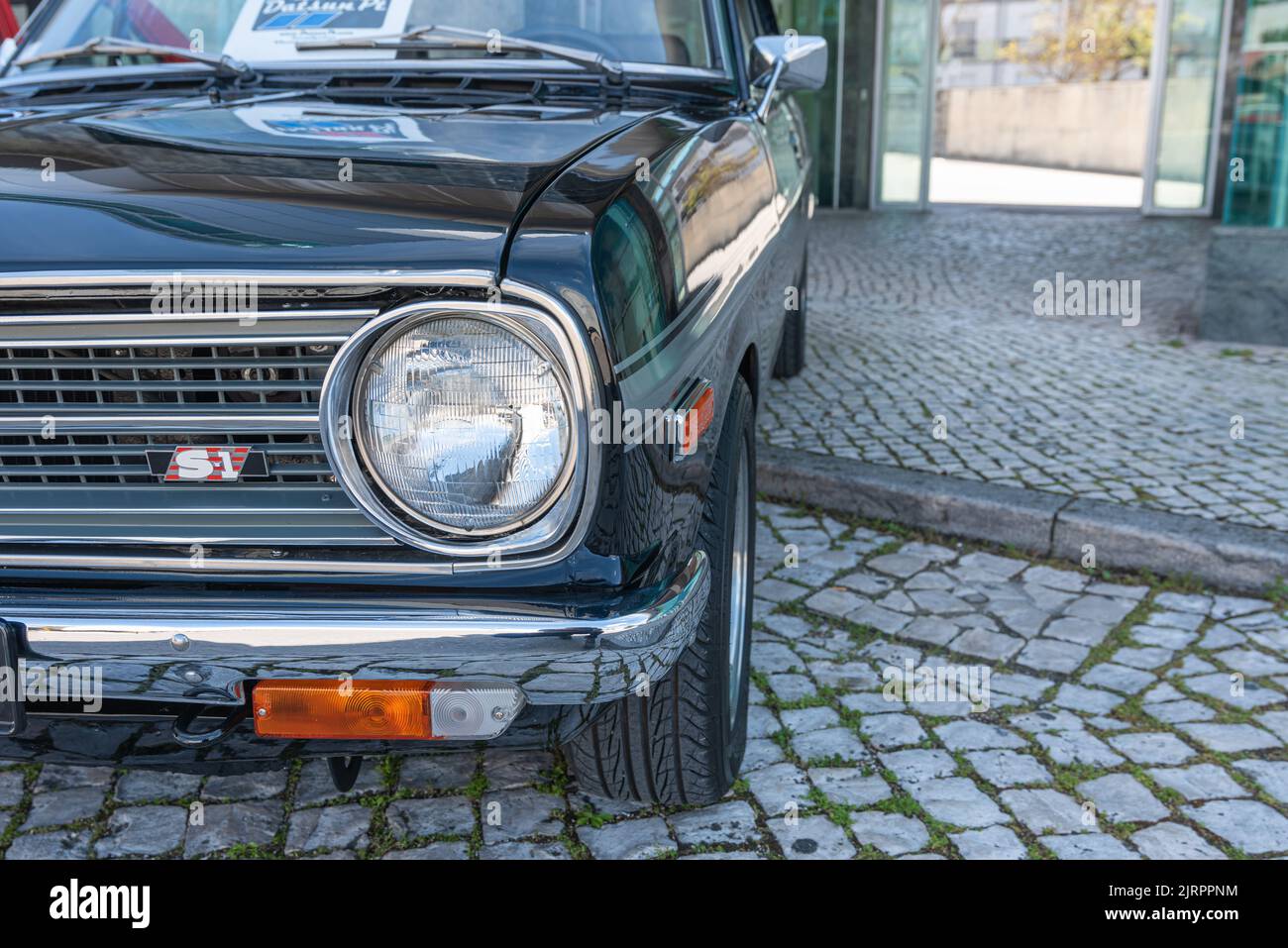 A closeup of the front of a beautiful shiny Nissan Datsun 1200 car Stock Photo