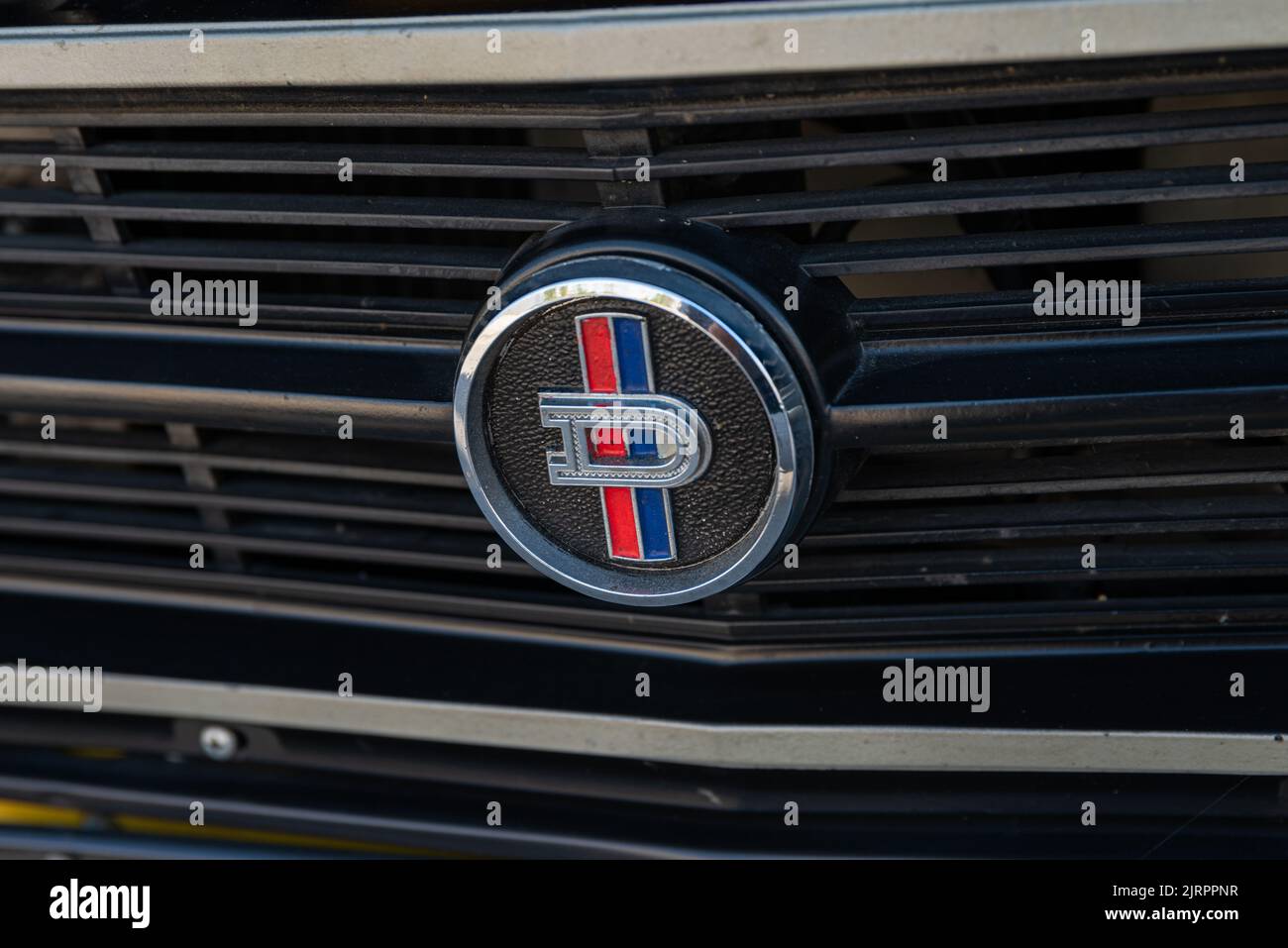 A closeup of grill emblem of a beautiful shiny Nissan Datsun 1200 car Stock Photo