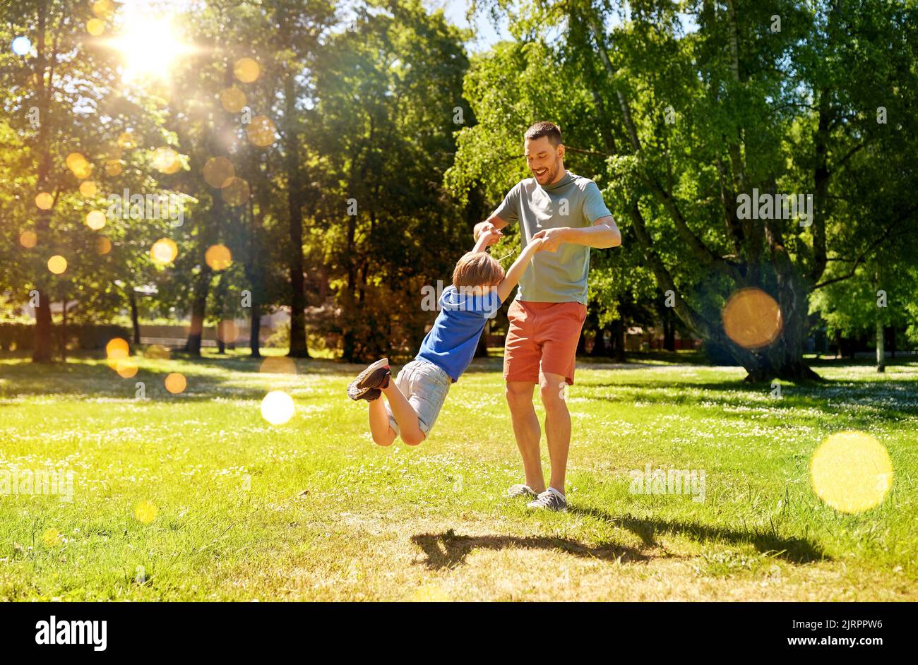 happy father with son playing in summer park Stock Photo - Alamy
